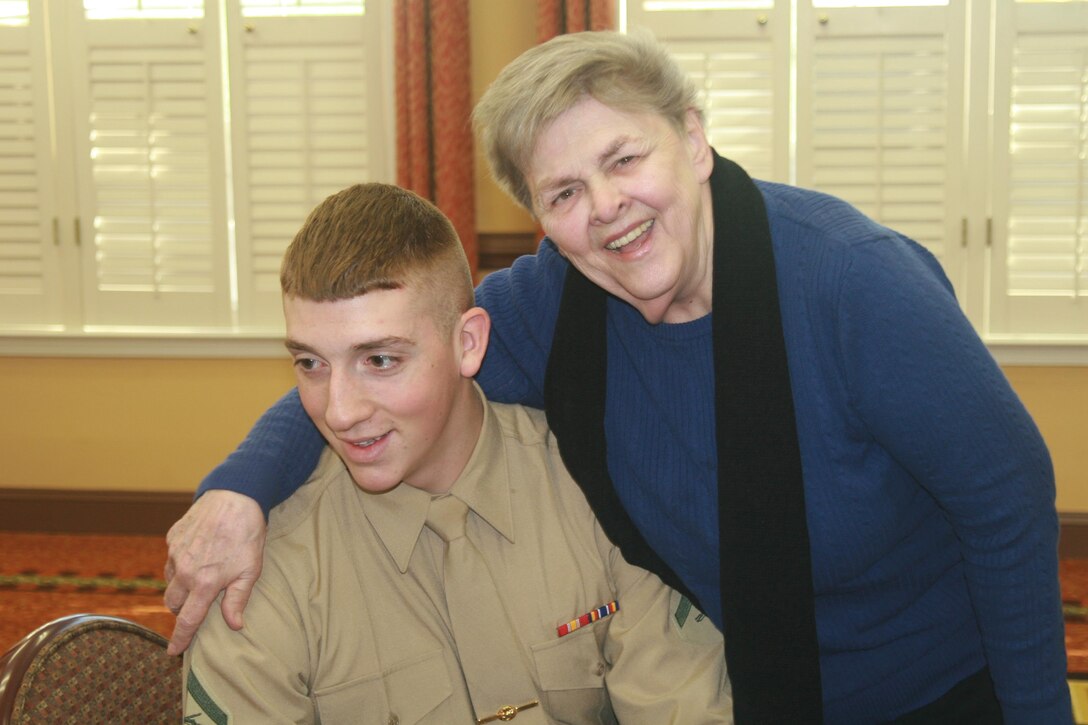 Nancy Boush can't resist hugging Lance Cpl. Gavin Hawkins, Headquarters and Service Battalion. Hawkins visited Boush and other residents of Heatherwood Retirement Community in Burke, Virginia, with other Marines from Marine Corps Base Quantico on Jan. 14.