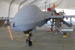 Unmanned aerial system repairers from Company F, 227th Aviation Regiment, 40th Combat Aviation Brigade, inspect an MQ-1C Gray Eagle in the Middle East, Jan. 7, 2016. Company F Gray Eagles provide armed aerial reconnaissance for stability operations in the Middle East. 