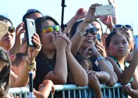A concert goer watches as the lead singer of Magic! takes a photo with her cell phone during Beach Fest on Joint Base Pearl Harbor-Hickam, Hawaii, Jan. 16, 2016. Beach Fest, a joint event held by MWR and Armed Forces Entertainment brought games and entertainment together with a live concert. (U.S. Air Force photo by Tech. Sgt. Aaron Oelrich/Released)   