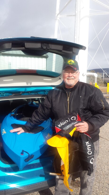 COCHITI LAKE, N.M. -- Ned Lundquist poses with his life jacket and kayak after his experience on the lake.
