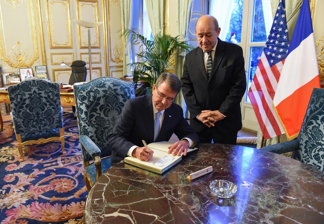U.S. Defense Secretary Ash Carter, left, signs a guest book as French Defense Minister Jean-Yves Le Drian looks on in Paris, Jan. 20, 2016, before the two leaders discussed efforts to fight the Islamic State of Iraq and the Levant. DoD photo by Army Sgt. 1st Class Clydell Kinchen