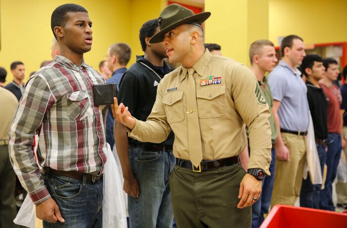 Staff Sergeant Joshua M. Cardona, drill instructor, Receiving Company, Support Battalion, instructs a new recruit to respond louder during receiving at Marine Corps Recruit Depot San Diego, Jan. 19. Recruits must respond to everything a drill instructor says and develop instant obedience to orders. Annually, more than 17,000 males recruited from the Western Recruiting Region are trained at MCRD San Diego. Mike Company is scheduled to graduate April 15.