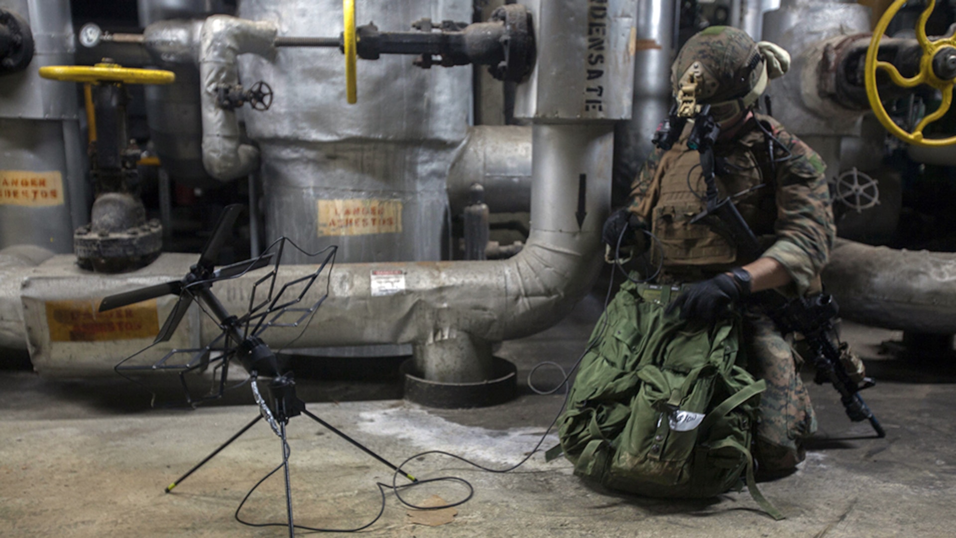 Staff Sgt. Travis Caron sets up satellite communications during a raid Jan. 13, 2015, as part of Realistic Urban Training Exercise on Guam. RUTEX is a high-intensity close-quarter battle training exercise conducted in an actual urban environment to provide a high degree of realism to the training. The exercise is part of the Maritime Raid Force’s pre-deployment training before their upcoming deployment with the 31st MEU. Caron, from Sneads Ferry, North Carolina, is the Force Reconnaissance Platoon communications chief with MRF, 31st MEU. 