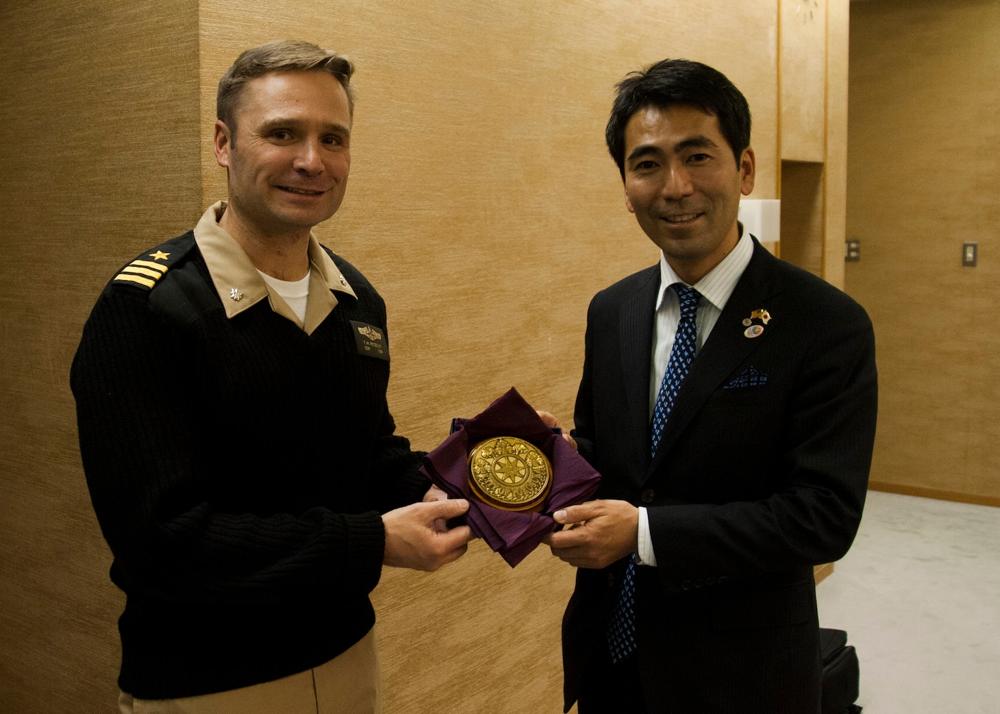 160113-N-ED185-031
YOKOSUKA, Japan (Jan. 13, 2016) Mayor Yuto Yoshida, City of Yokosuka, presents a plaque to Cmdr. Travis Petzoldt, commanding officer of the Los Angeles-class fast-attack submarine USS Corpus Christi (SSN 705), at the Yokosuka City Hall. The two leaders met to commemorate the sister cities relationship between the city of Corpus Christi and Yokosuka. This is City of Corpus Christi’s last port visit to Japan prior to the boat’s decommissioning. (U.S. Navy photo by Mass Communication Specialist 2nd Class Brian G. Reynolds/Released)
