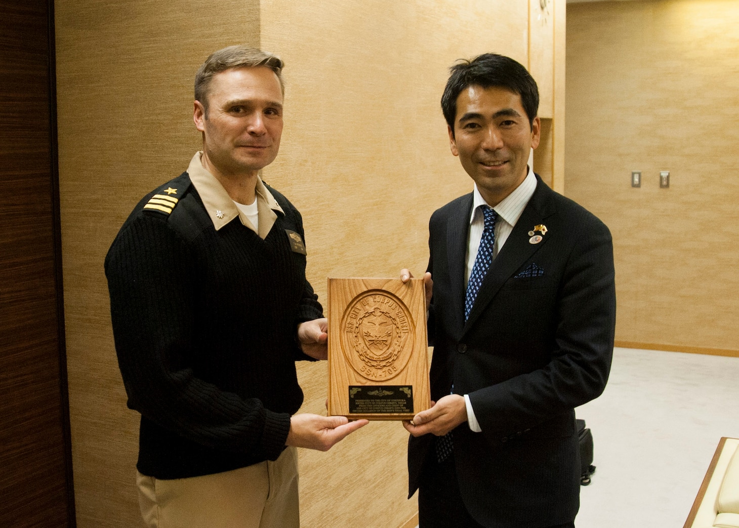160113-N-ED185-036
YOKOSUKA, Japan (Jan. 13, 2016) Cmdr. Travis Petzoldt, commanding officer of the Los Angeles-class fast-attack submarine USS Corpus Christi (SSN 705), presents a plaque to Mayor Yuto Yoshida, City of Yokosuka, at the Yokosuka City Hall. The two leaders met to commemorate the sister cities relationship between the city of Corpus Christi and Yokosuka. This is City of Corpus Christi’s last port visit to Japan prior to the boat’s decommissioning. (U.S. Navy photo by Mass Communication Specialist 2nd Class Brian G. Reynolds/Released)

