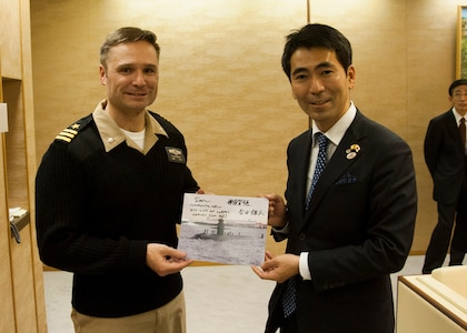 160113-N-ED185-042
YOKOSUKA, Japan (Jan. 13, 2016) Cmdr. Travis Petzoldt, commanding officer of the Los Angeles-class fast-attack submarine USS Corpus Christi (SSN 705), presents a signed photo of the boat to Mayor Yuto Yoshida, City of Yokosuka, at the Yokosuka City Hall. The two leaders met to commemorate the sister cities relationship between the city of Corpus Christi and Yokosuka. This is City of Corpus Christi’s last port visit to Japan prior to the boat’s decommissioning. (U.S. Navy photo by Mass Communication Specialist 2nd Class Brian G. Reynolds/Released)
