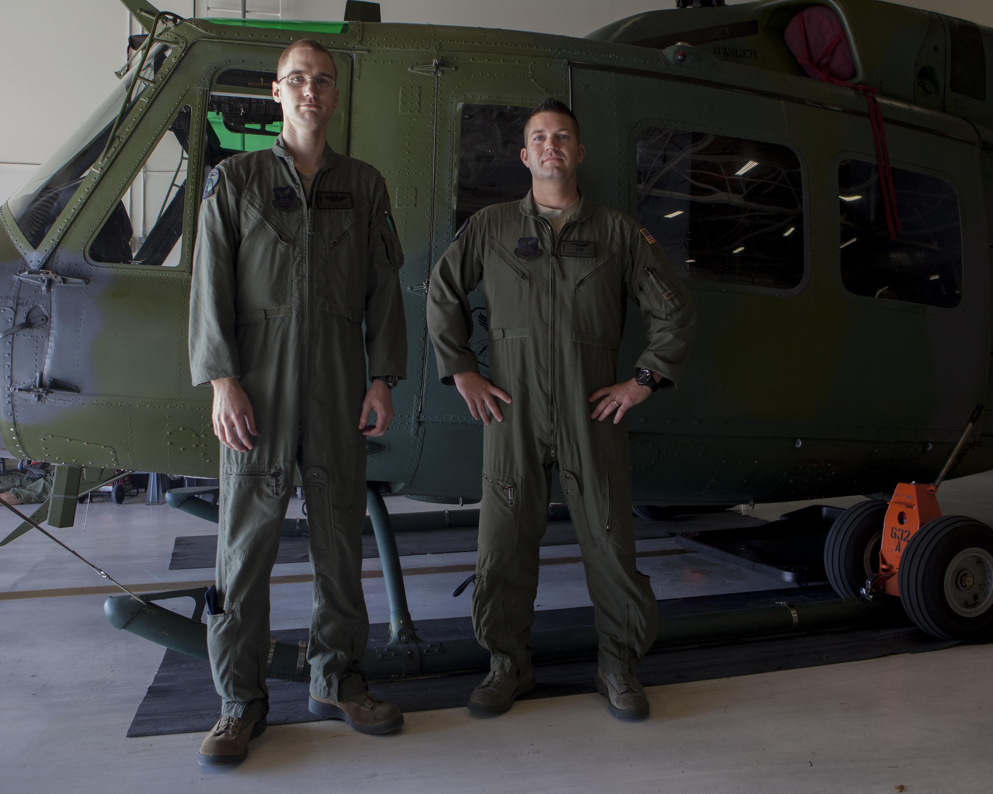 Capt. Stephen Jones, 37th Helicoptor Squadron command pilot and Staff Sgt. Brice Marshall, 37th HS flight engineer, pose with a UH-1N Huey helicopter on F.E. Warren Air Force Base, Wyo., Jan. 20, 2016. Jones and Marshall were part of a search and rescue mission that saved two lives on Jan. 18.   (U.S. Air Force photo by Lan Kim)