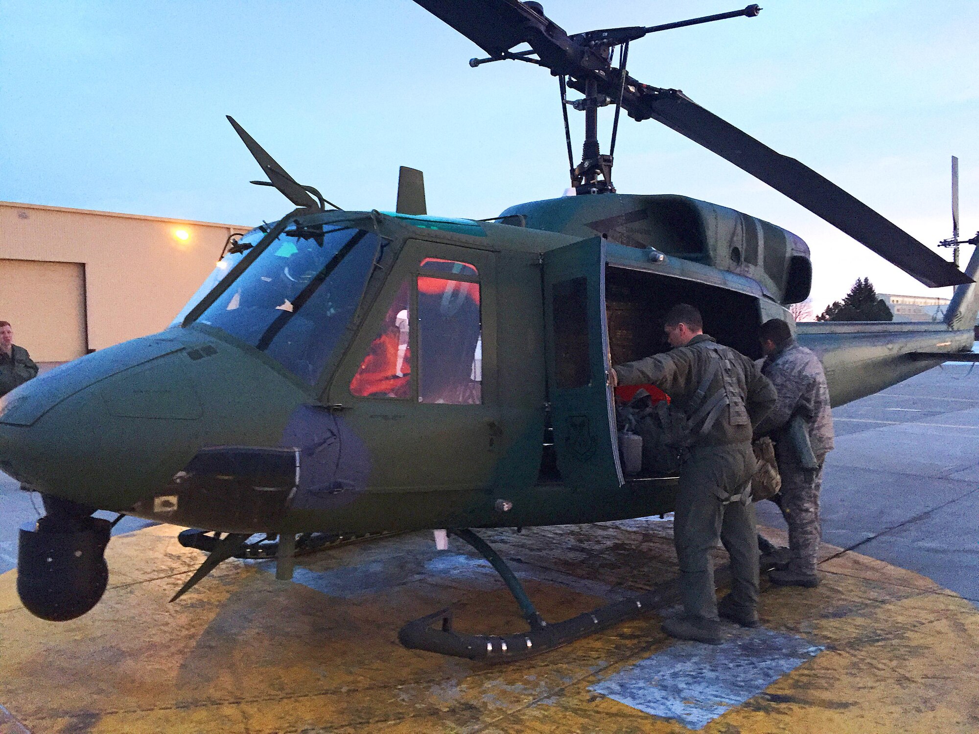 1st Lt. Mathew Brox, 37th Helicopter co-pilot and Lt. Col. Michael Clay, 90th Medical Operations on-board flight medic, set preparations for a search and rescue mission on F.E. Warren Air Force Base, Wyo., Jan. 18, 2016. A 37th HS aircrew successfully rescued two lives in southern Wyoming. (Courtesy Photo)