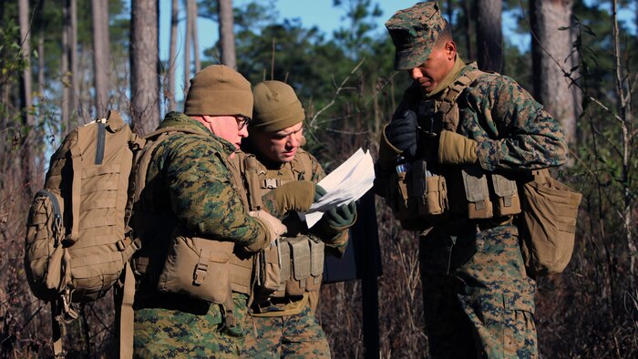Marines with Marine Wing Support Squadron 274’s Engineer Company, Heavy Equipment Platoon review their map during a land navigation course at Marine Corps Air Station Cherry Point, N.C., Jan. 13, 2016. During the 19-point course, 20 Marines headed to the field to re-experience the basic land navigation process. The course was a refresher for most of the Marines, who have not used land navigation since Marine Combat Training.