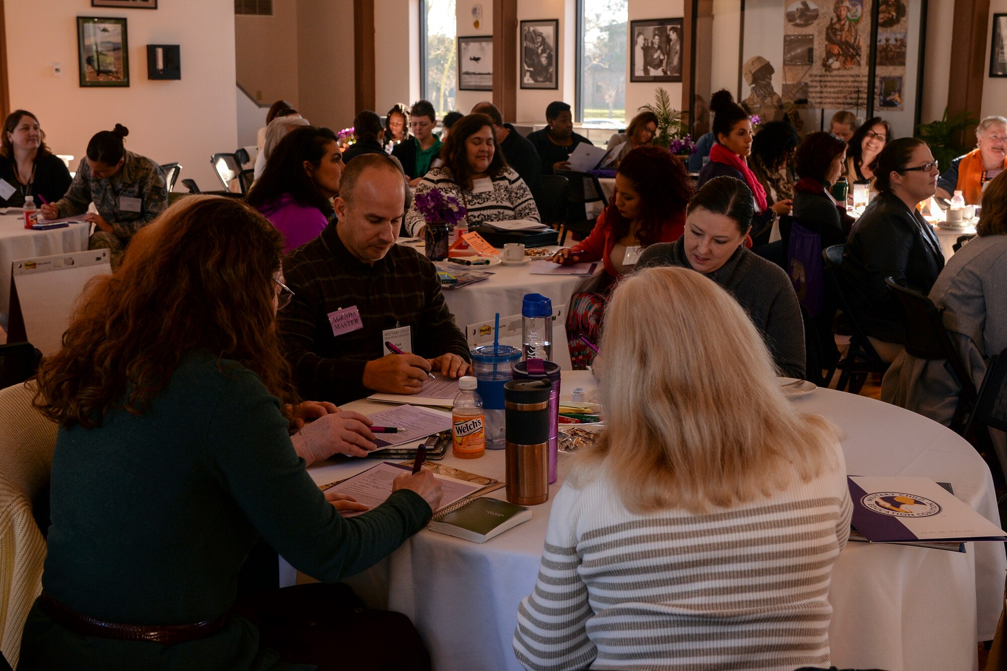 Participants fill out information sheets at the beginning of a Military Child Education Coalition sponsored training class, Jan. 20, 2016, at Moody Air Force Base, Ga. Attendees discussed ways to identify with and better serve military children. (U.S. Air Force photo by Airman 1st Class Janiqua P. Robinson/Released)