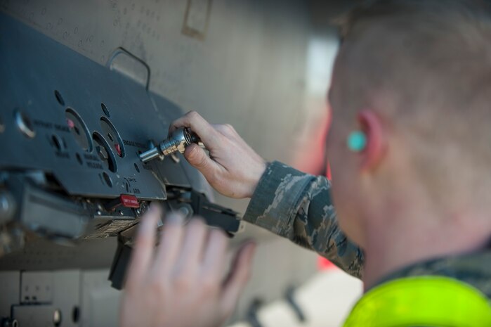 Senior Airman Michael Flatt, Strike Aircraft Maintenance Unit weapons load crew member, prepares an F-15E Strike Eagle aircraft to be loaded with munitions during a quarterly weapons load crew competition at Nellis Air Force Base, Nev., Jan. 8, 2016. In addition to recognizing superior performers, load crew competitions also help keep weapons loaders’ skills sharp and ready for real-world situations. (U.S. Air Force photo by Staff Sgt. Siuta B. Ika)