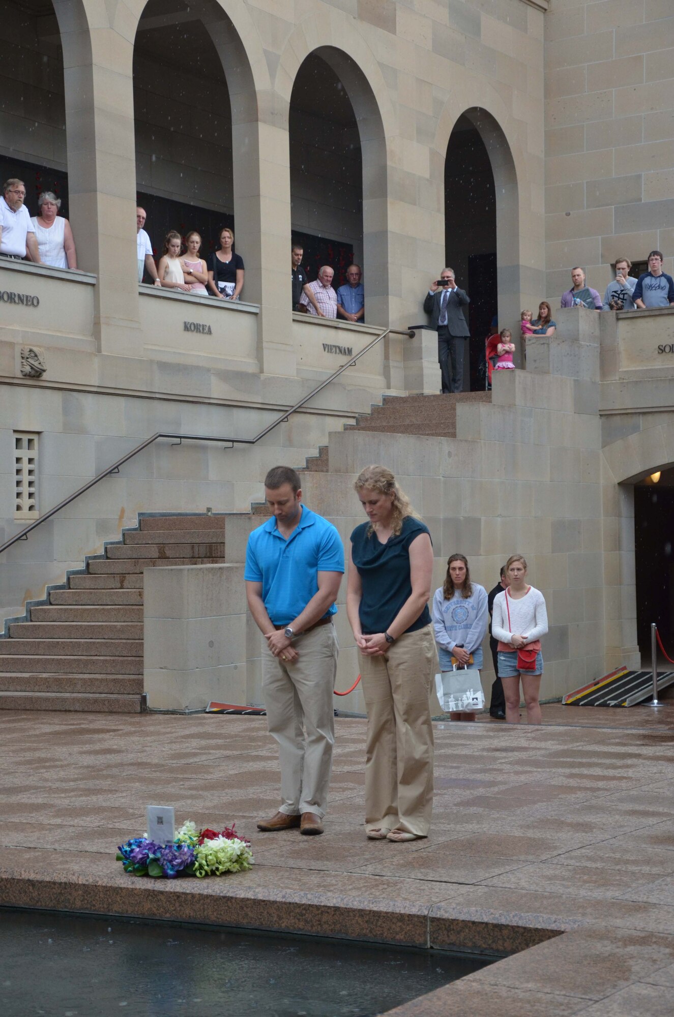 Maj. Jesse Foster (left), commander of Detachment 421 in Alice Springs, Australia, and Col. Jennifer P. Sovada, commander of the Air Force Technical Applications Center, Patrick AFB, Fla., pause for a moment of silence after laying a wreath at the Australian War Memorial in Canberra Dec. 16, 2015.  Sovada traveled to the detachment to observe the seismic work being performed by the Airmen under her command as part of AFTAC's worldwide nuclear treaty monitoring mission. (U.S. Air Force photo by Susan A. Romano)