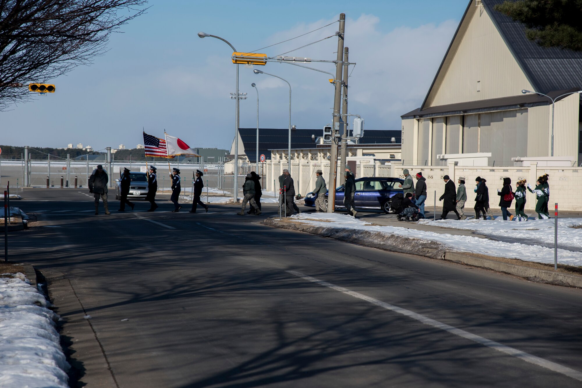 Airmen and students at Edgren High School march during the Martin Luther King, Jr. Day observance day held at Misawa Air Base, Japan, Jan. 15, 2016. The march started at the Enlisted Club and ended at Edgren High School where an assembly was held. Martin Luther King, Jr. was an American Baptist minister, activist, humanitarian and leader in the African-American Civil Rights Movement. He is best known for his role in the advancement of civil rights using nonviolent civil disobedience based on his Christian beliefs. (U.S. Air Force photos by Senior Airman Brittany A. Chase)