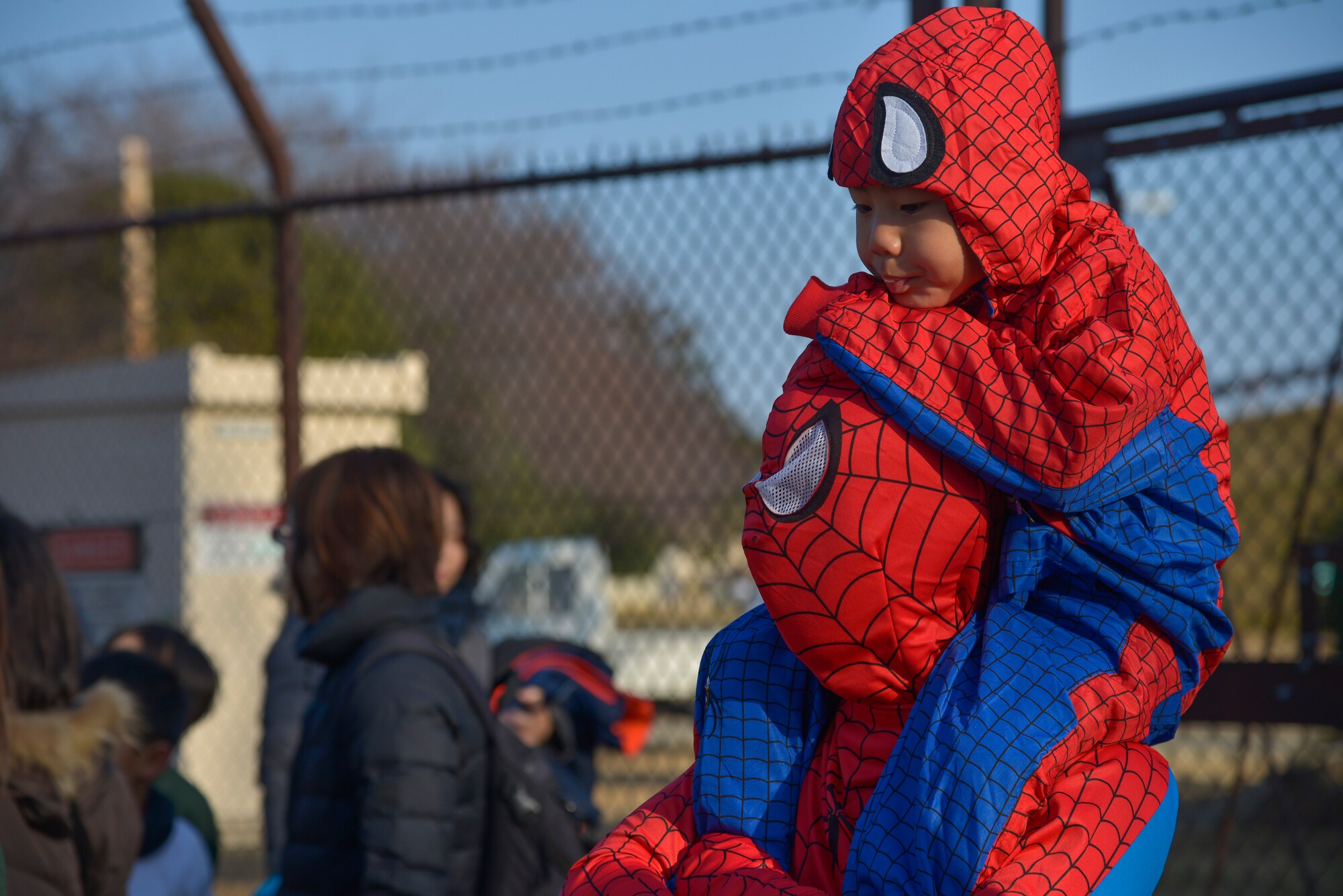 A child sits on his father’s shoulders before the 2k children’s race during the 35th Annual Frostbite Run at Yokota Air Base, Japan, Jan. 17, 2015. The run had three other races for people to participate in; a 2k family race, 5k race and a half marathon. (U.S. Air Force photo by Senior Airman David Owsianka/Released)