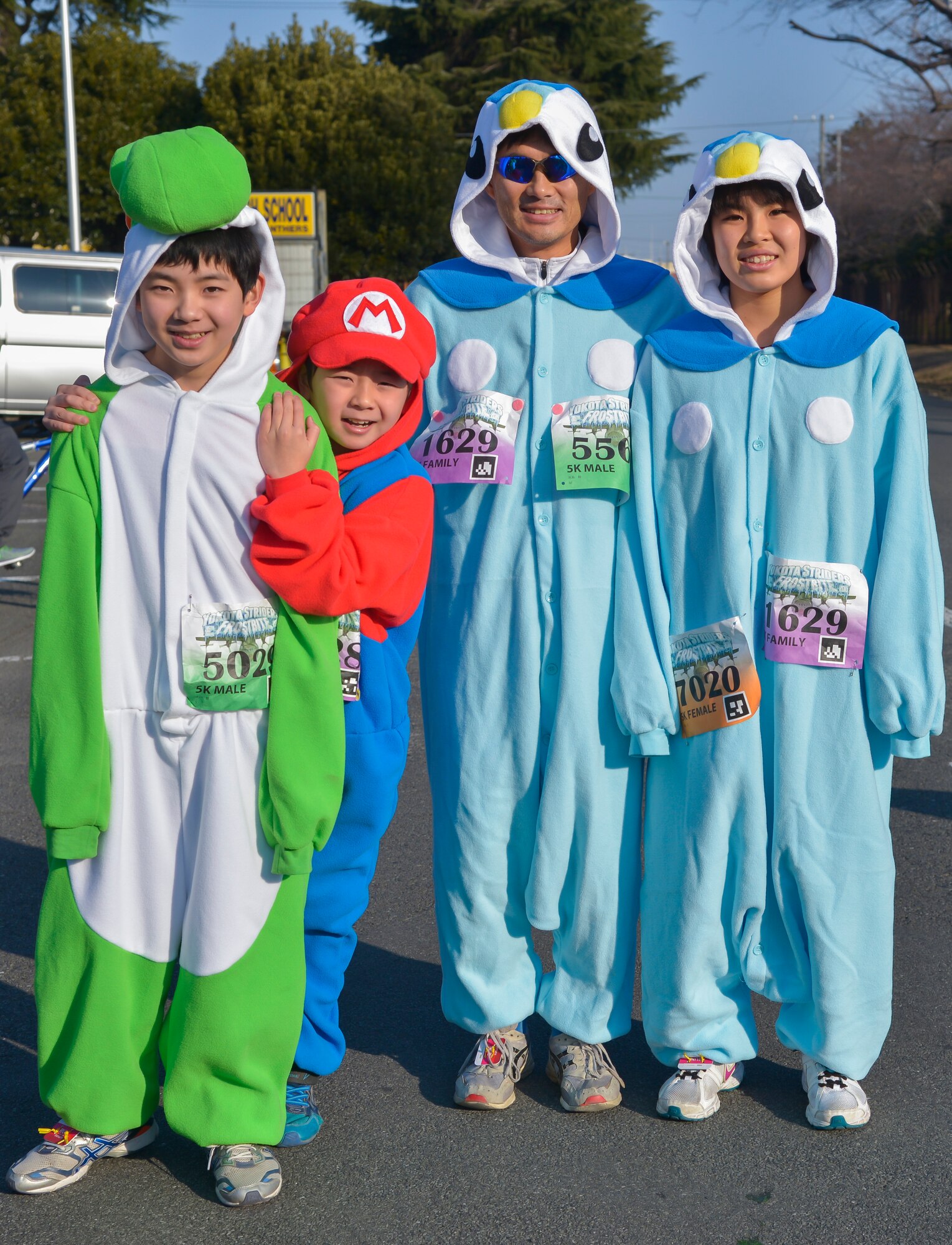 A family poses for a picture before the Frostbite Run at Yokota Air Base, Japan, Jan. 17, 2015. Participants wore various costumes such as Spiderman, Ironman and Batman during the run. (U.S. Air Force photo by Senior Airman David Owsianka/Released)