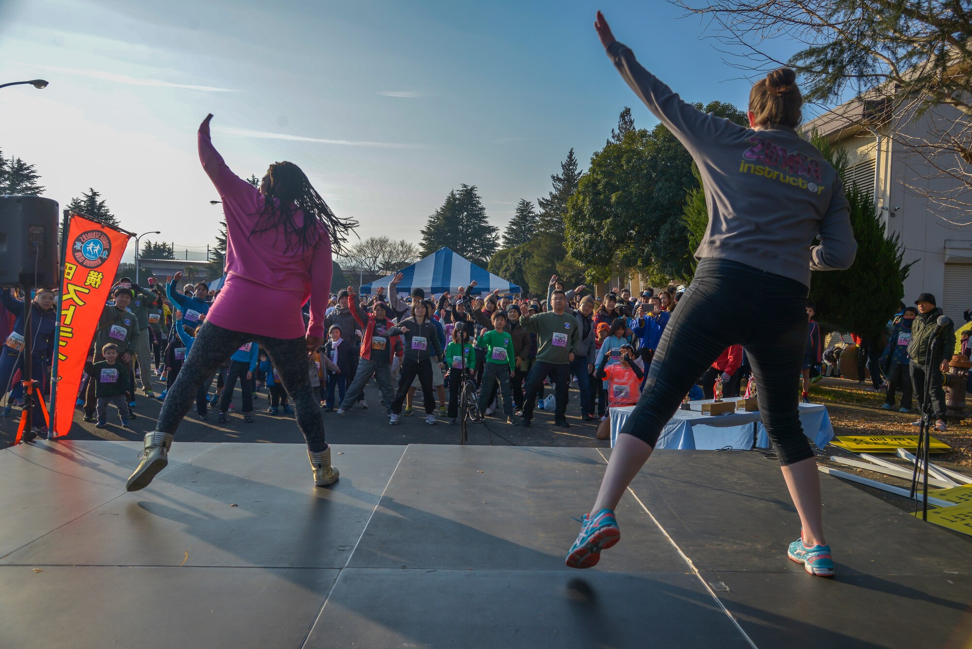 Participants in the 35th Annual Frostbite Run perform a Zumba style warm-up before the run at Yokota Air Base, Japan, Jan. 17, 2015. The run had approximately 9,000 participants. (U.S. Air Force photo by Senior Airman David Owsianka/Released)