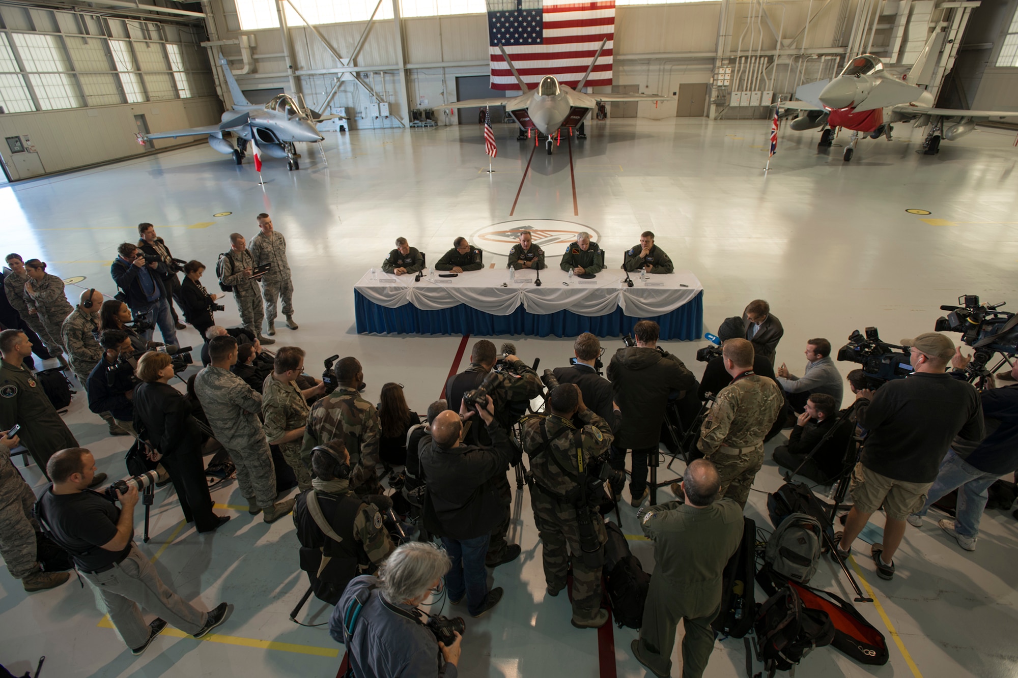 Distinguished visitors from the U.S., U.K., and French air forces answer questions during a press conference hosted during the Trilateral Exercise at Langley Air Force Base, Va., Dec. 15, 2015. The exercise is intended to train coalition fighters to respond and work together during highly-contested, degraded and operationally-limited environments (U.S. Air Force photo by Tech. Sgt. Katie Gar Ward)