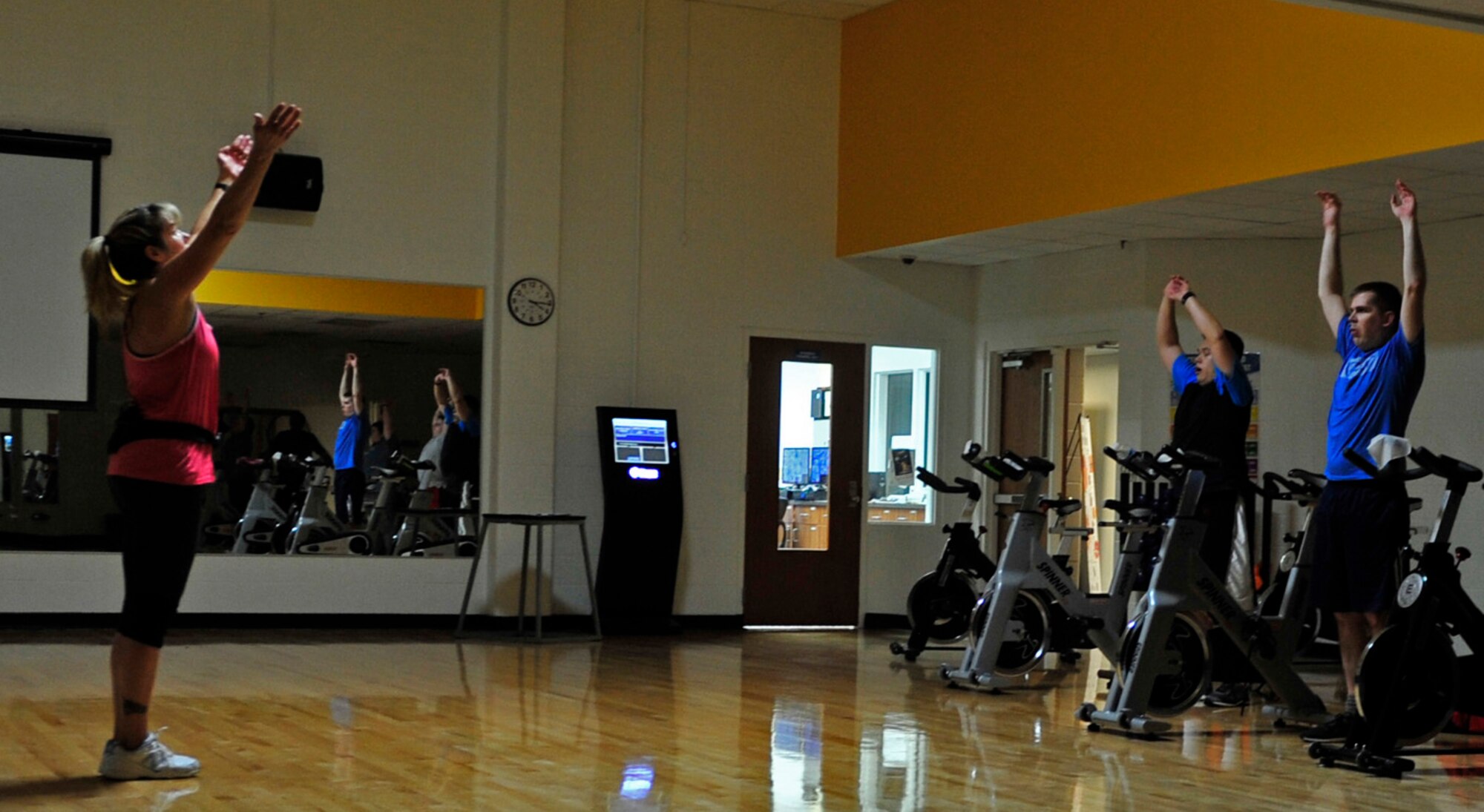 Geri Seal, 28th Medical Operations Squadron health promotion program manager, leads stretches after spin class at Ellsworth Air Force Base, S.D., Jan. 13, 2016. As the health promotion program manager, Seal teaches Better Body Better Life and VA MOVE!, and assists servicemembers in developing healthy living habits.  (U.S. Air Force photo by Airman 1st Class James L. Miller/Released)