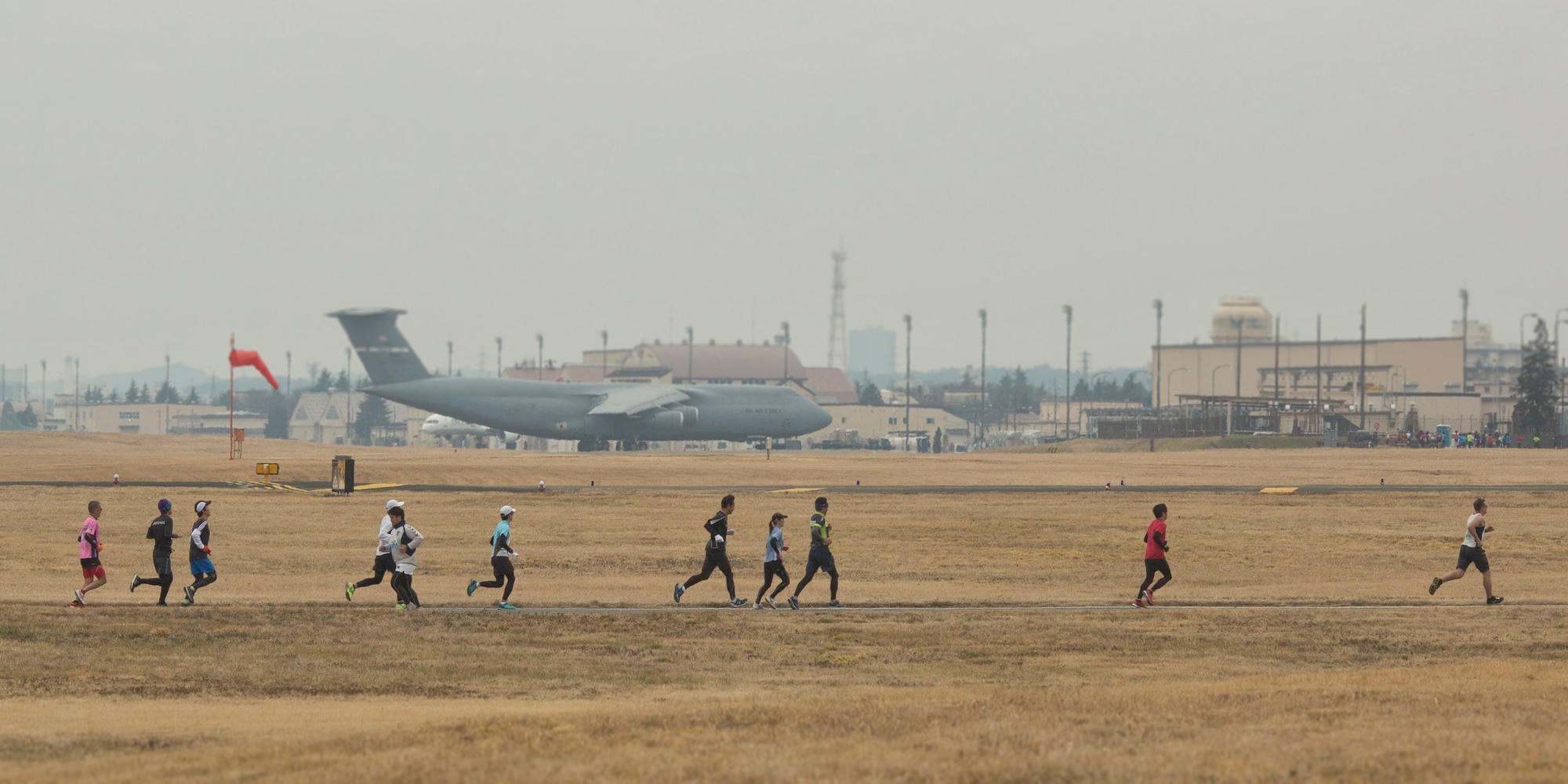 Japanese race participants run around Yokota Air Base, Japan, Jan. 17, 2016, during the 35th Annual Frostbite Run. Team Yokota hosted over 9,000 participants for the event, hosting multiple 2Ks, a 5K and a half marathon. (U.S. Air Force photo by Osakabe Yasuo/Released)