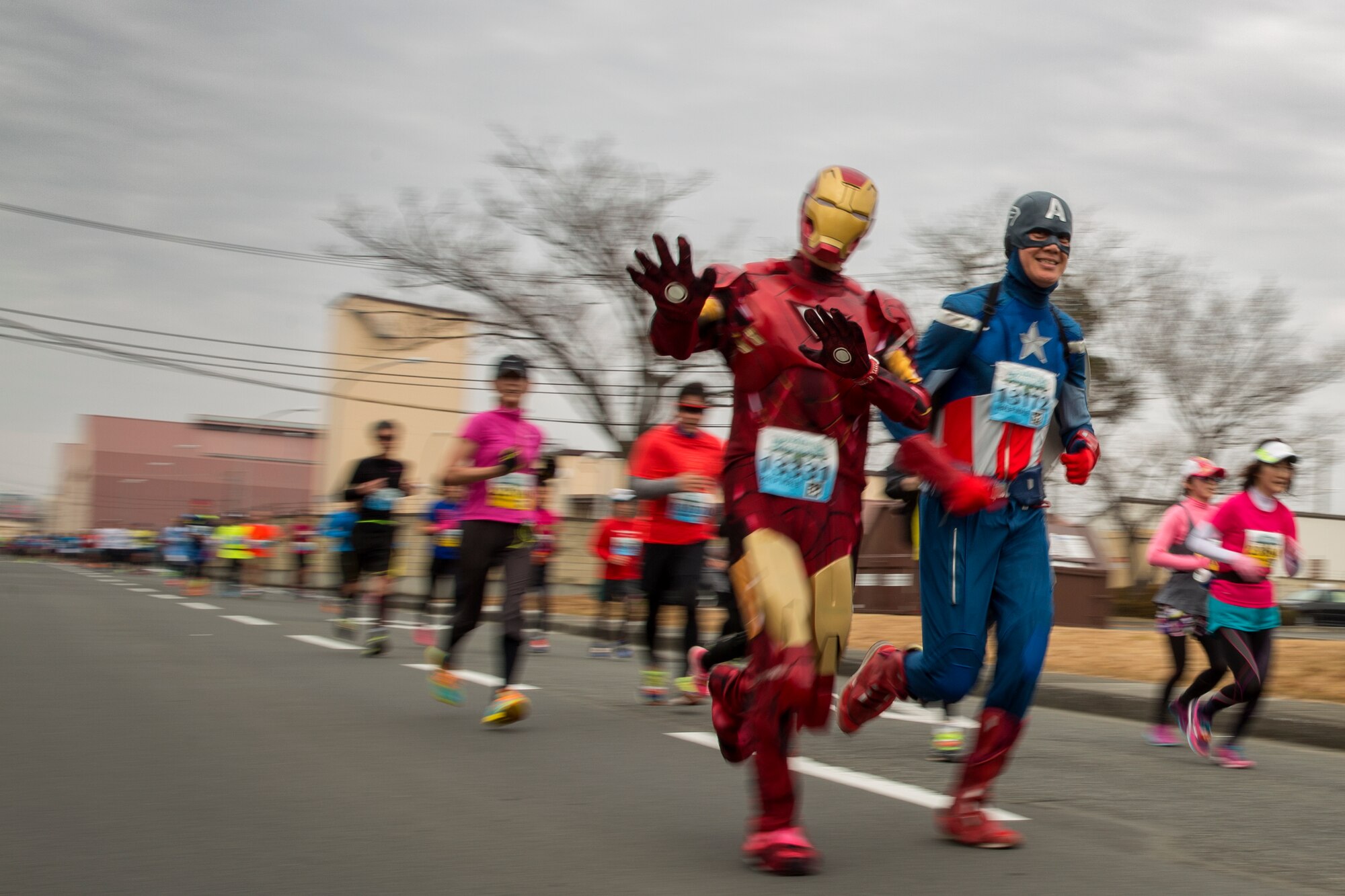 Runners dressed as Iron man and Captain America participate in the 35th Annual Frostbite Run at Yokota Air Base, Japan, Jan. 17, 2016. Some of the 9,000 runners who participated wore costumes, an established custom during the event. (U.S. Air Force photo by Osakabe Yasuo/Released)