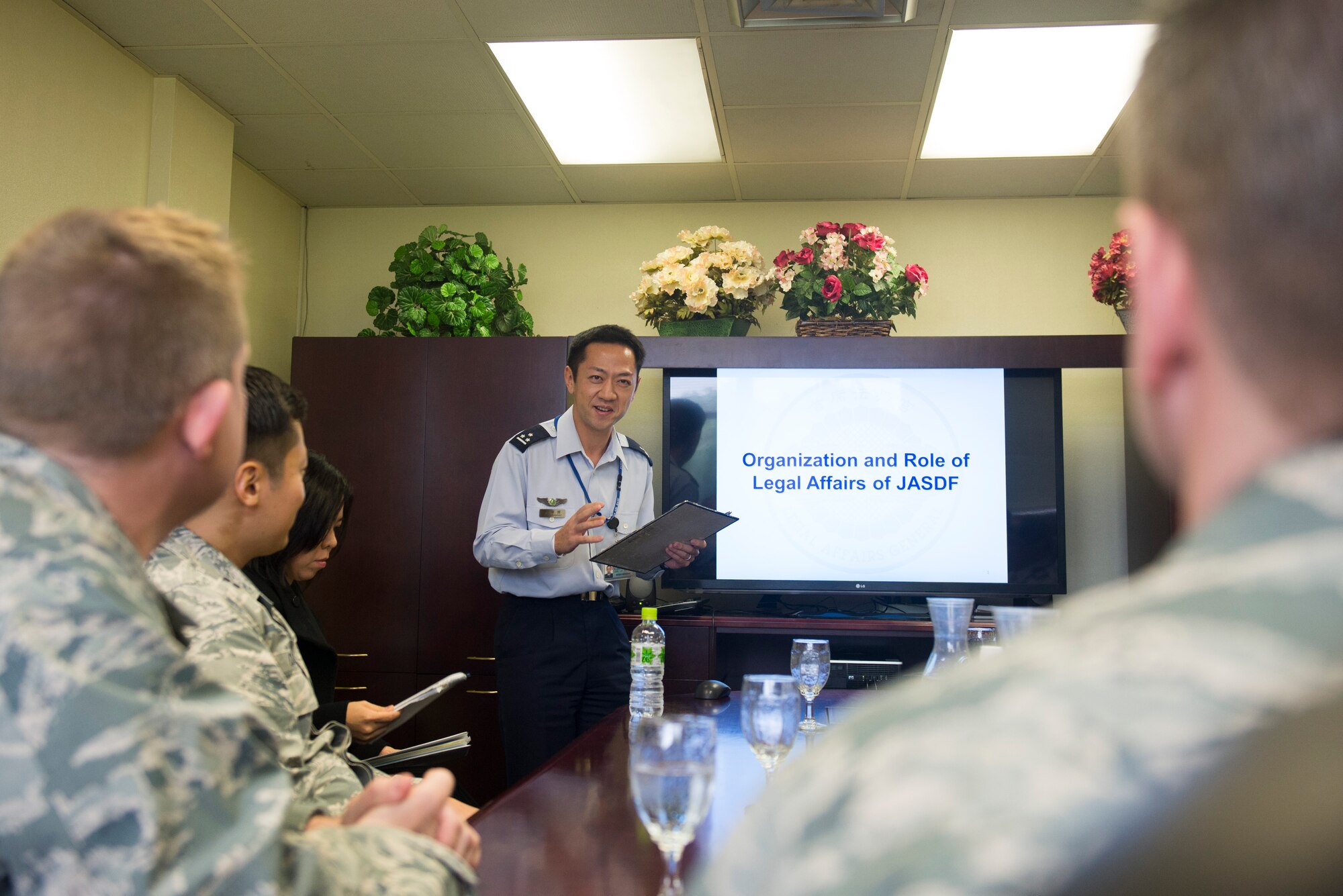 Japan Air Self Defense Force Capt. Daisuke Kusabiraki, South West Composite Air Command legal officer, explains the organization and role of the JASDF Legal Affairs office to members of the 18th Wing legal office Jan. 20, 2016, at Kadena Air Base, Japan. The 18th Wing legal office provided a tour of the installation to their JASDF counterparts to foster and strengthen relations between the U.S. Air Force and JASDF. (U.S. Air Force photo by Senior Airman Omari Bernard) 