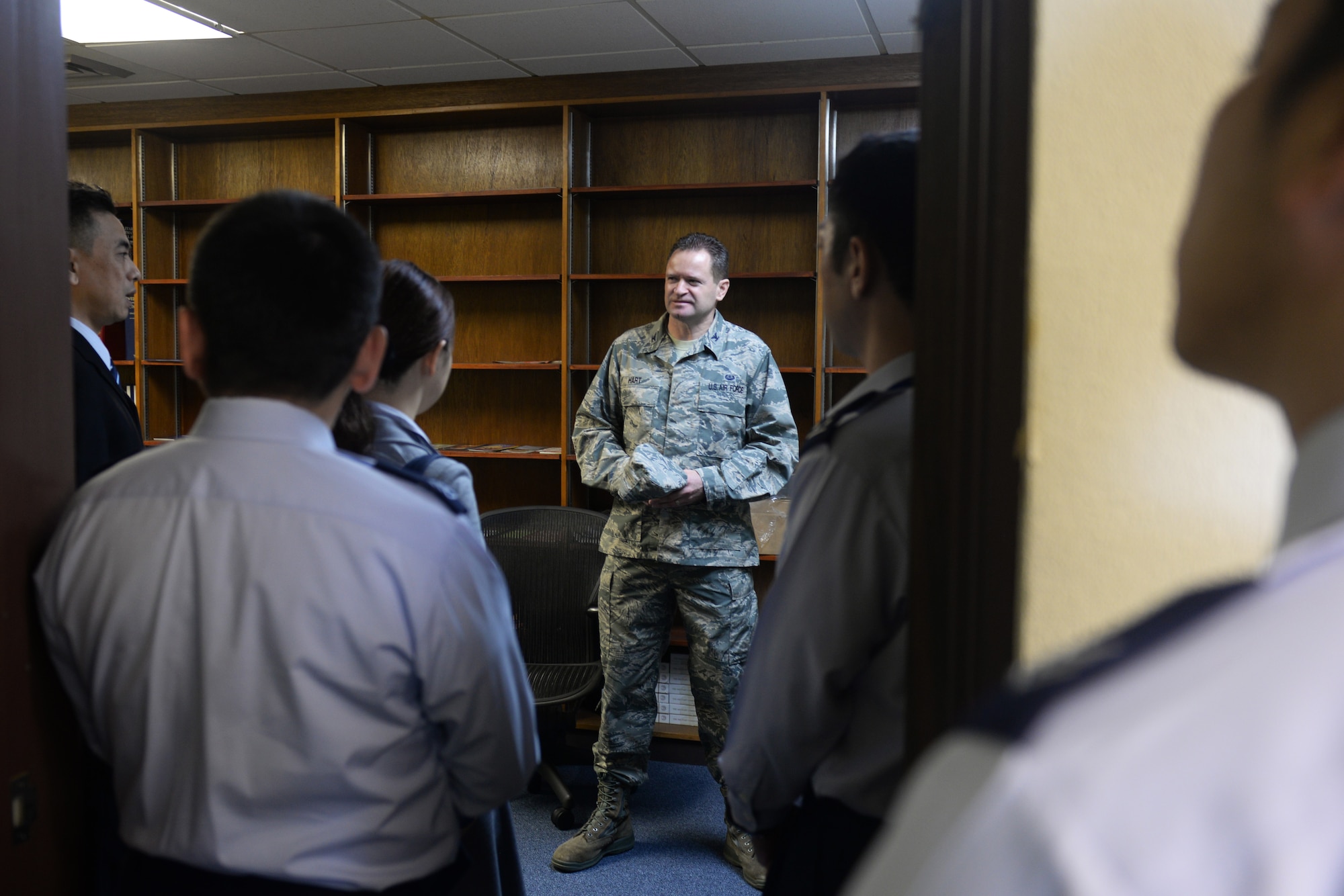 U.S. Air Force Col. Brandon Hart, 18th Wing staff judge advocate, gives members of the Japan Air Self Defense Force Legal Affairs office a tour of their facilities Jan. 20, 2016, at Kadena Air Base, Japan. The tour allowed the 18th Wing legal office to provide a better understanding of their day-to-day operations to their JASDF counterparts. (U.S. Air Force photo by Senior Airman Omari Bernard)
