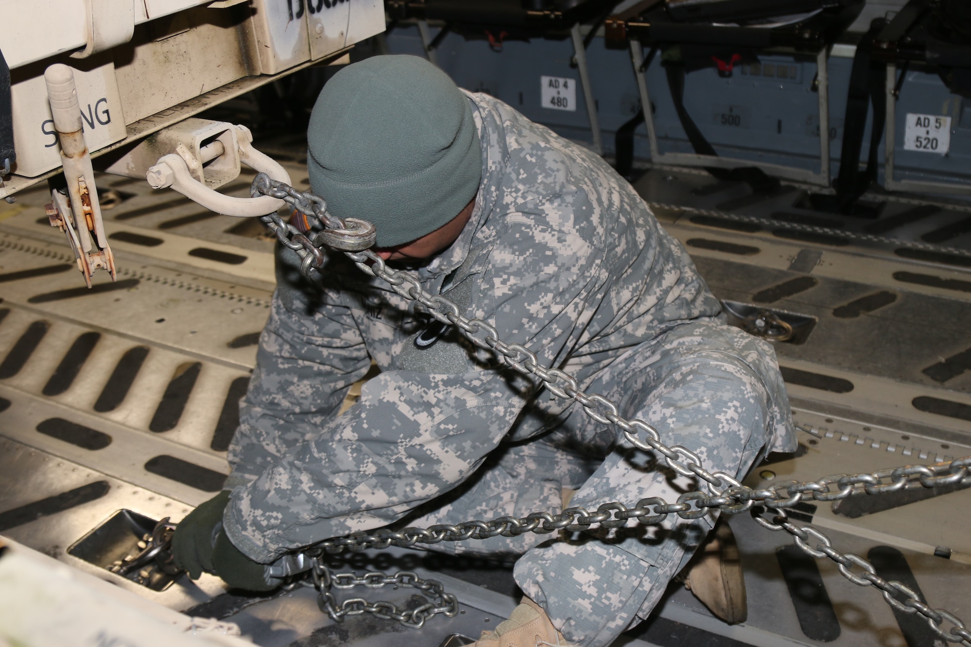 A Soldier from the I Corps Early Entry Command Post ties down a generator trailer inside an Air Force C-17 during static load training at McChord Field. Washington, Jan. 13. The EECP can deploy on order and set up a command post within the U.S. Army Pacific area of responsibility within 96 hours. (U.S. Army photo by Sgt. Leon Cook)