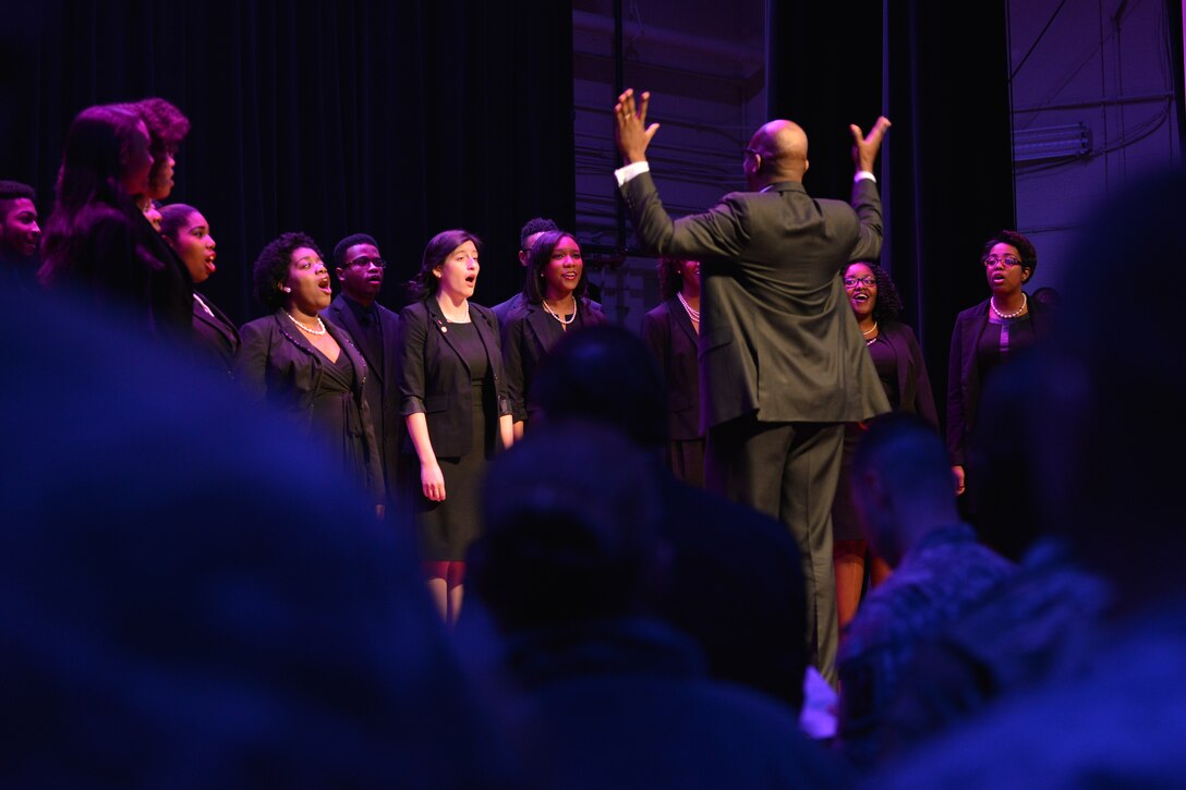Joint Base Langley-Eustis members join the Hampton University Choir in singing during a Dr. Martin Luther King Day Celebration at Fort Eustis, Va., Jan. 13, 2016. The audience and choir sang “Lift Every Voice and Sing,” in unison, marking the end of the celebration. (U.S. Air Force photo by Staff Sgt. Natasha Stannard)