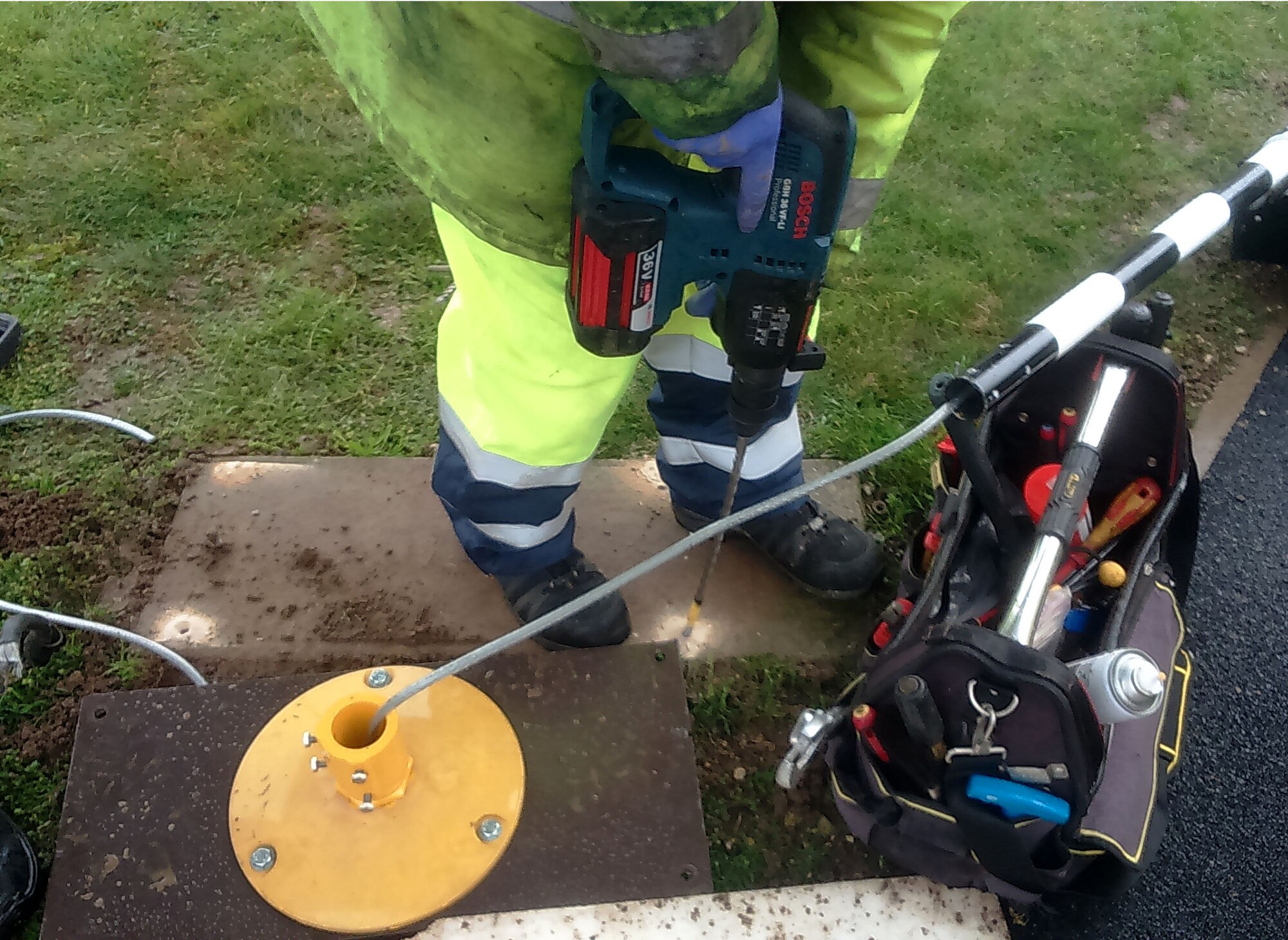 Members of the 100th Civil Engineer Squadron fix the base plate into position to mount the new traffic lights Nov. 4, 2015, on RAF Mildenhall, England. The airfield lighting team designed, built and implemented a raised perimeter road traffic light system to improve airfield safety. (Courtesy photo/Released)