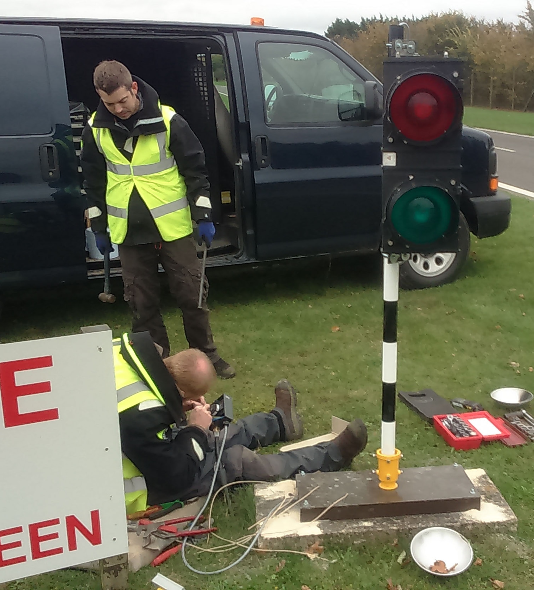 Members of the 100th Civil Engineer Squadron, connect the electrical control cables to the new perimeter road traffic lights Nov. 10, 2015, on RAF Mildenhall, England. These lights have been changed for safety reasons to stop vehicles entering the instrument landing system controlled areas. (Courtesy photo/Released)