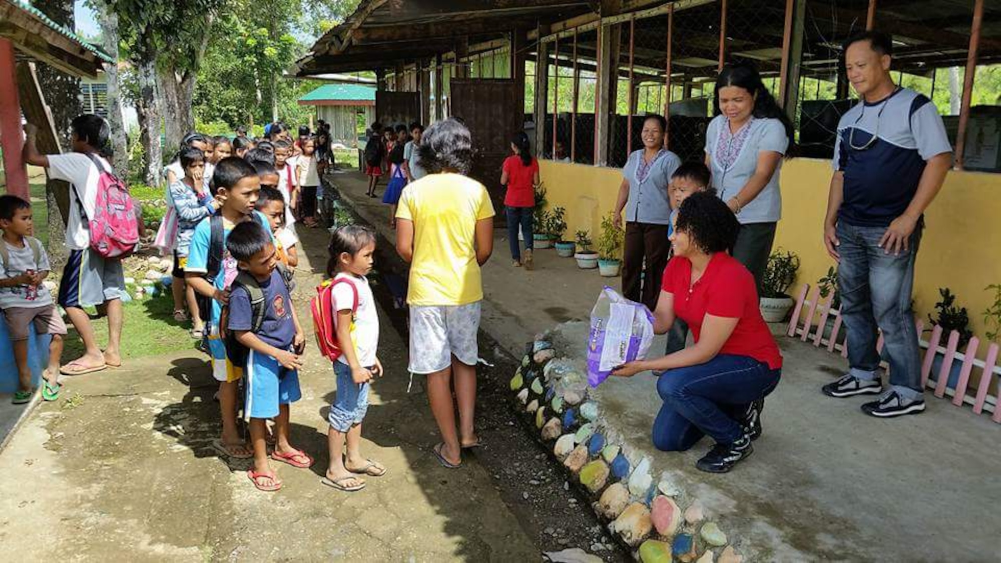 Air Force 1st Lt. Joy Johnson, 773d Civil Engineer Squadron operations engineering officer in charge, hands out candy to children at Jaena Norte elementary school, in Panay, Philippines during a site visit. Personnel with the 673d Civil Engineer Group conducted site visits prior to starting a renovation project for the school, scheduled for March 28, as part of a humanitarian and civic assistance portion of exercise Balikatan 2016. (Courtesy photo) 






