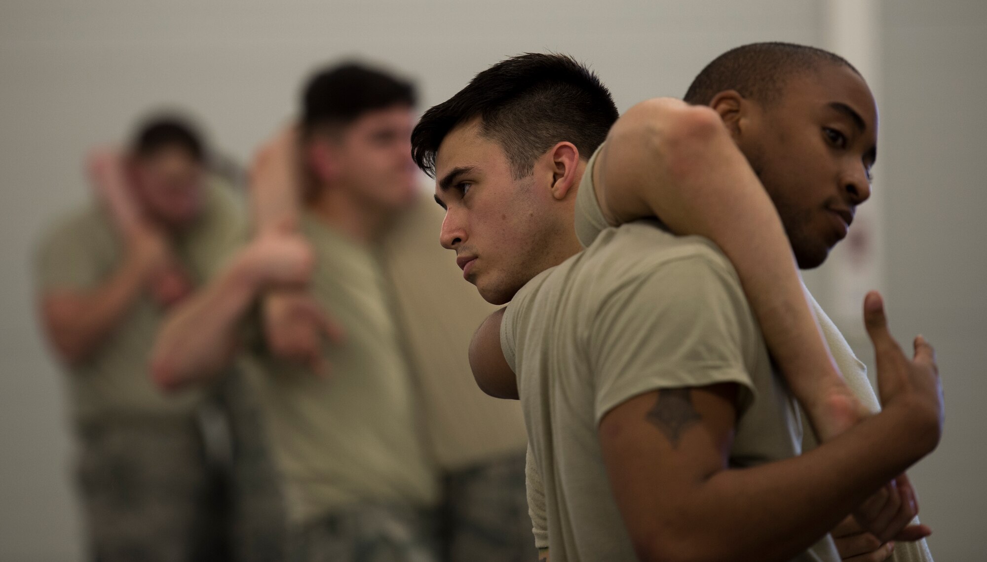 Senior Airman George Henry III and Staff Sgt. Wilbertson Smith, both patrolmen with the 423rd Security Forces Squadron from RAF Alconbury, United Kingdom, practice self-defense maneuvers during a Security Forces combative course Jan. 14, 2016, at Ramstein Air Base, Germany. The seven-day course is designed to teach security forces members weapon retention and self-defense so they can handle hostile situations in the most peaceful means necessary. (U.S. Air Force photo/Senior Airman Jonathan Stefanko)