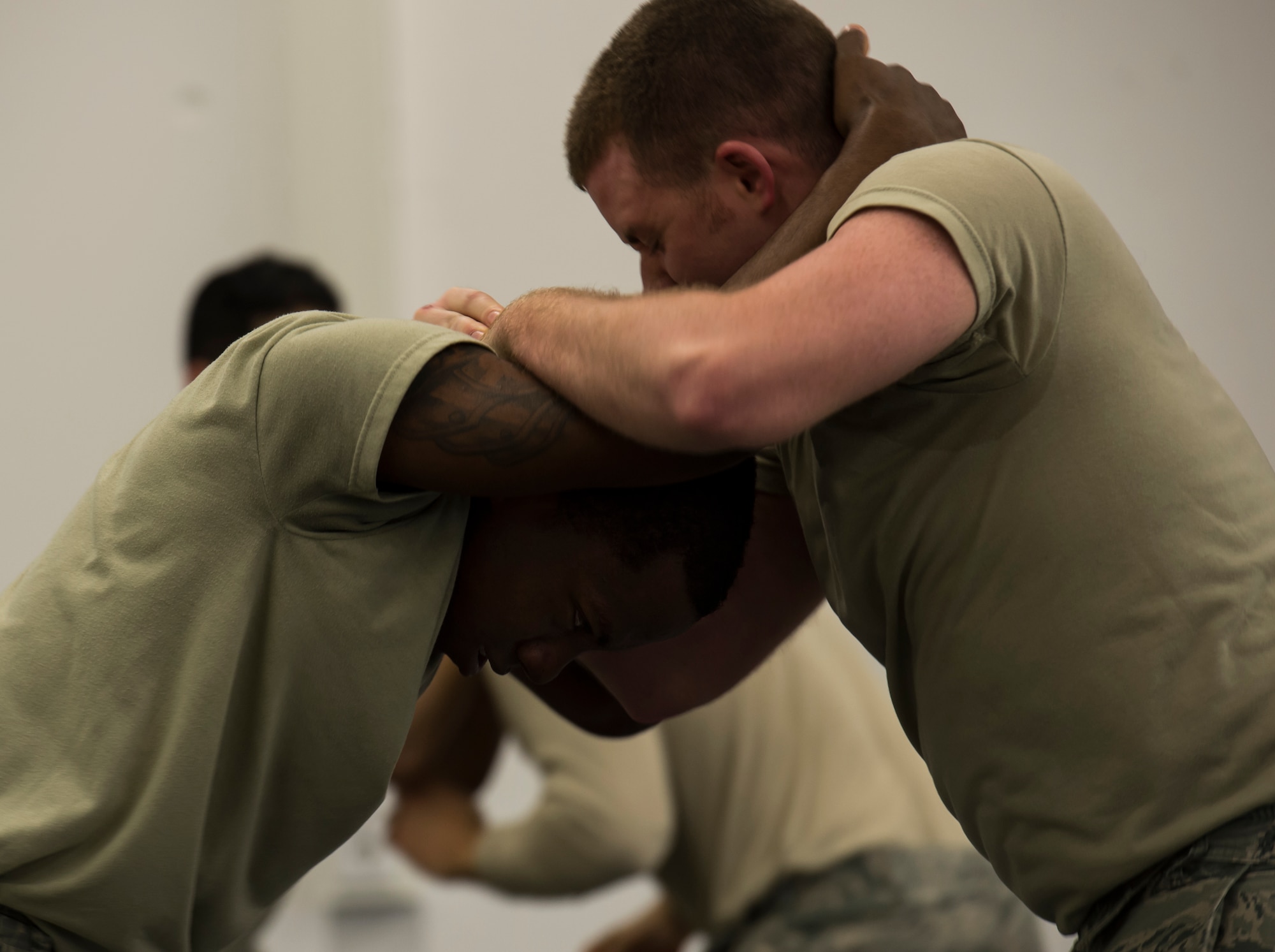Senior Airman Michael Kurtz, 52nd Security Forces Squadron patrolman from Spangdahlem Air Base, Germany, and Airman 1st Class Nakealius Ards, 65th SFS patrolman from Lajes Field, Portugal, practice self-defense maneuvers during a Security Forces combative course Jan. 14, 2016, at Ramstein Air Base, Germany. The course is designed to help defenders gain the skills, knowledge and confidence they need in order to protect and serve. (U.S. Air Force photo/Senior Airman Jonathan Stefanko)