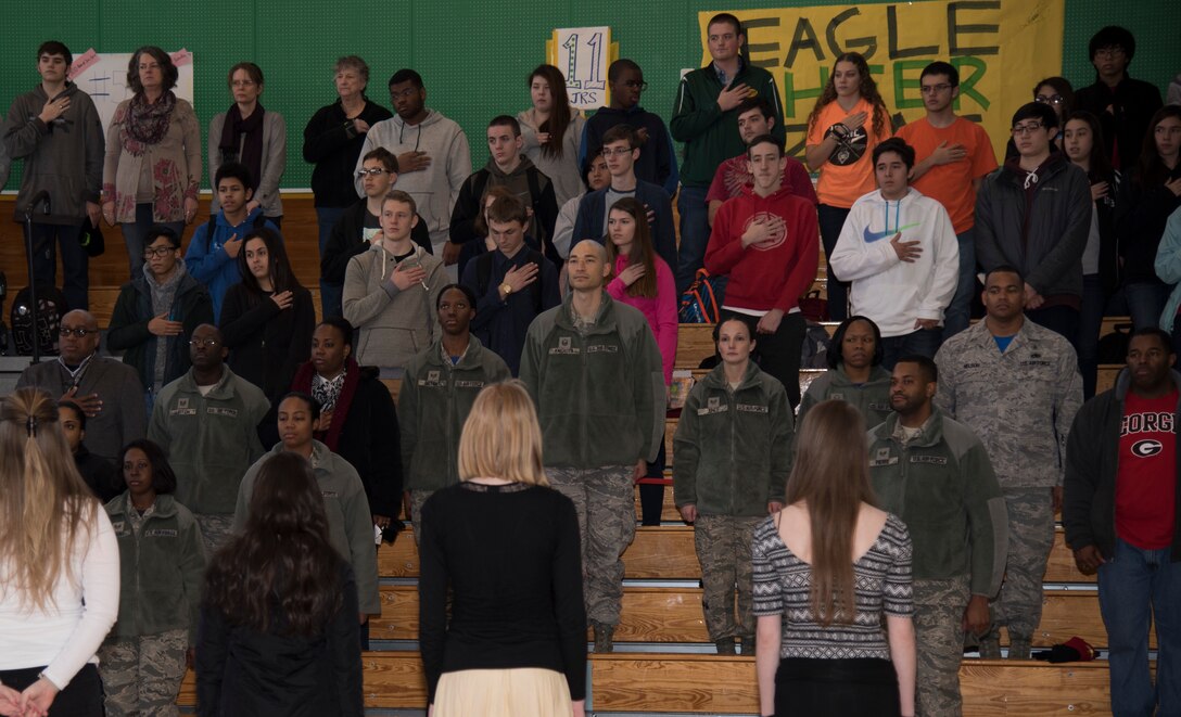 Airmen and students at Edgren High School stand for the singing of the national anthems at Misawa Air Base, Japan, Jan. 15, 2016. The three-hour event consisted of a luncheon, observance march and assembly held at Edgren High School in honor of Martin Luther King, Jr. The campaign for a federal holiday in King's honor began soon after his assassination in 1968. President Ronald Reagan signed the holiday into law in 1983, and it was first observed three years later. (U.S. Air Force photos by Senior Airman Brittany A. Chase)