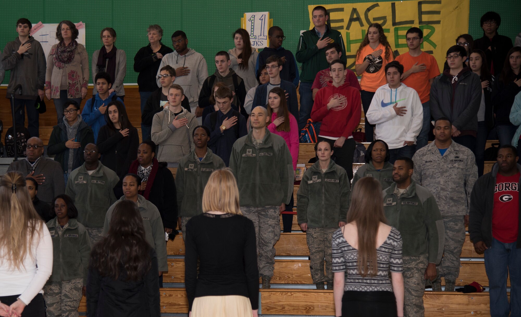 Airmen and students at Edgren High School stand for the singing of the national anthems at Misawa Air Base, Japan, Jan. 15, 2016. The three-hour event consisted of a luncheon, observance march and assembly held at Edgren High School in honor of Martin Luther King, Jr. The campaign for a federal holiday in King's honor began soon after his assassination in 1968. President Ronald Reagan signed the holiday into law in 1983, and it was first observed three years later. (U.S. Air Force photos by Senior Airman Brittany A. Chase)