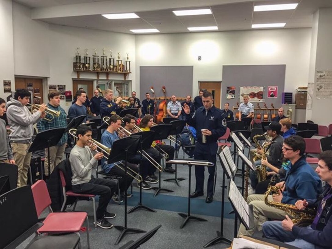 The Airmen of Note participated in an Advancing Innovation through Music (AIM) clinic with students of the Bethesda-Chevy Chase High School jazz ensemble.  Master Sergeant Tyler Kuebler, pictured, works with the full ensemble. (U.S. Air Force Photo/released)