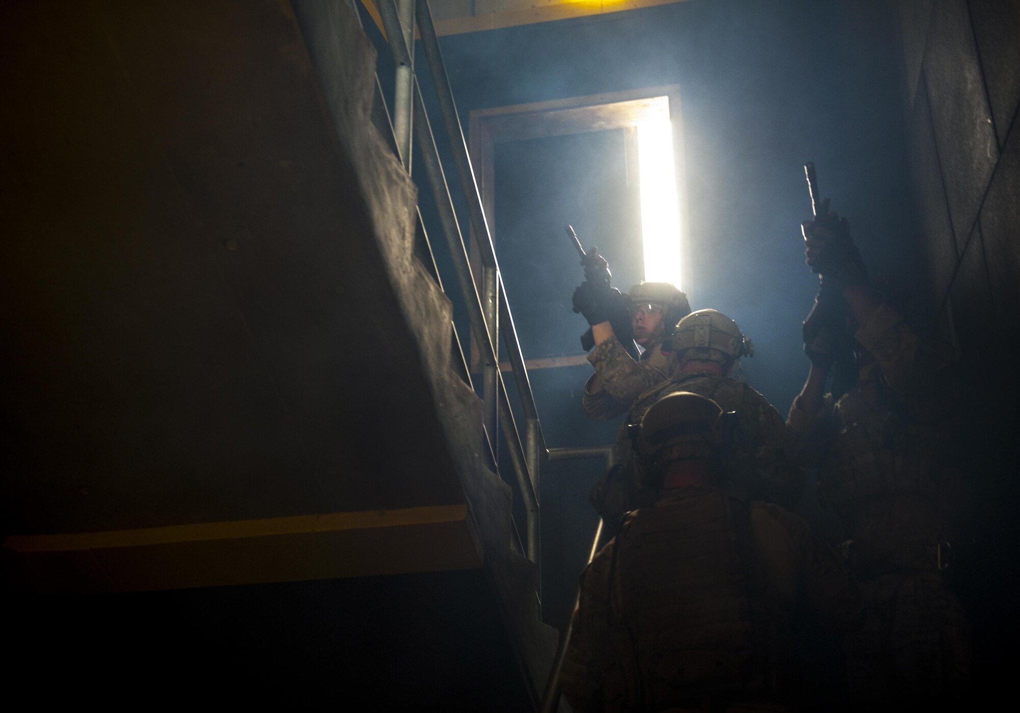 Deployed Aircraft Ground Response Element members practice tactical movement through a stairwell on Dec. 22, 2015 at Camp Hansen, Okinawa, Japan. As part of constant mission readiness, the annual training requirement for the DAGRE team member is 216 hours, but in the 2015 fiscal year, the 353rd Special Operations Support Squadron DAGRE unit trained for more than 400 hours. (U.S. Air Force photo by Airman 1st Class Nick Emerick)