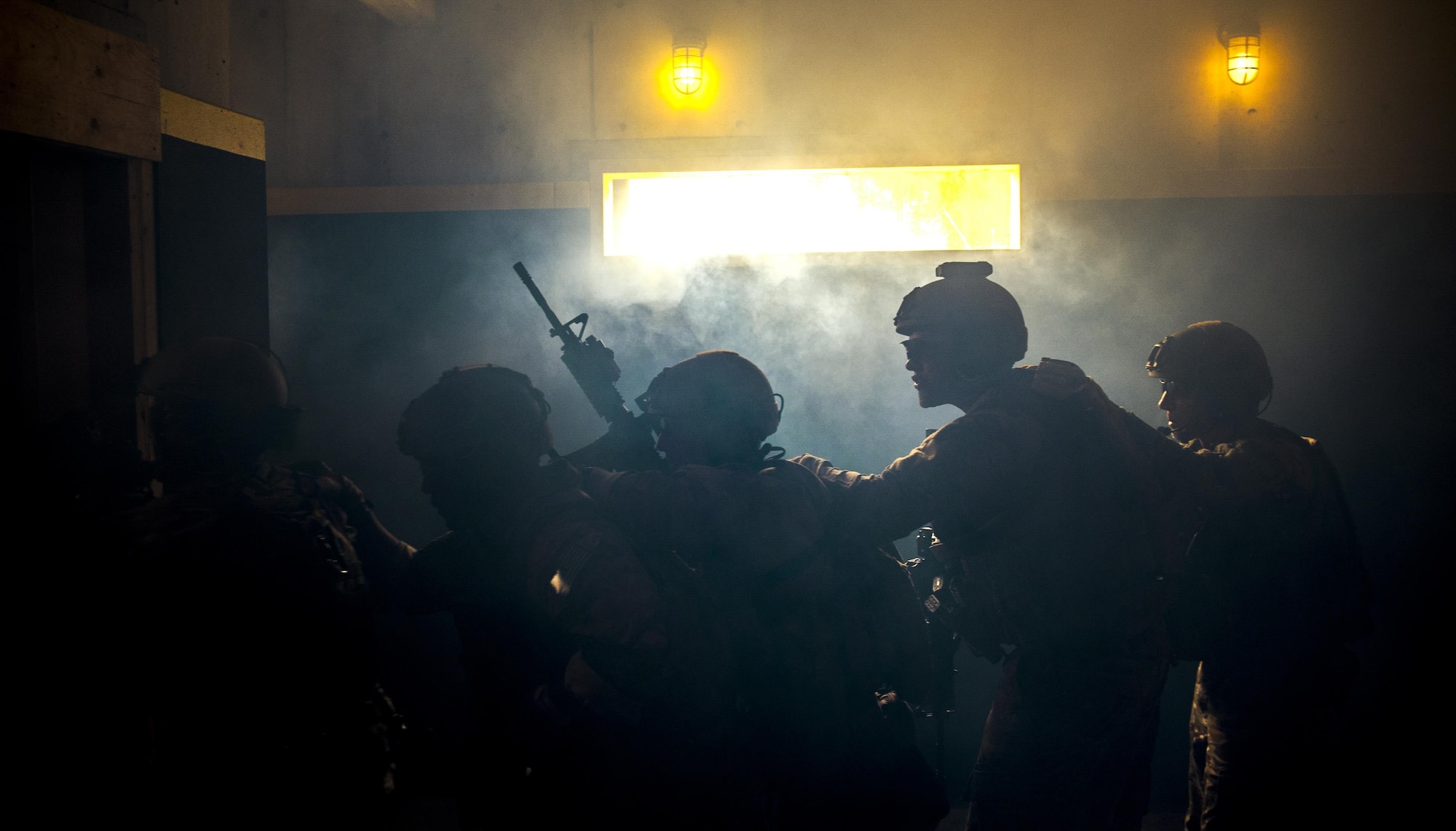 Deployed Aircraft Ground Response Element members stack up before heading through a door on Dec. 22, 2015 on Camp Hansen, Okinawa, Japan. The DAGRE is a group of highly trained Security Forces personnel that support Special Operations Command assets and resources worldwide. (U.S. Air Force photo by Airman 1st Class Nick Emerick)