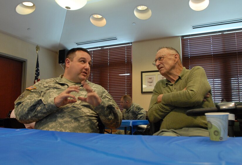 Sgt. Zach Mott, public affairs specialist with the U.S. Army Reserve’s 207th Public Affairs Detachment, swaps stories with a U.S. Army veteran during a visit to the Colorado State Veterans Home at Fitzsimmons, Jan. 9. Mott and the other Soldiers of the 207th PAD ate lunch and visited with the veterans who reside in the Veterans Home.