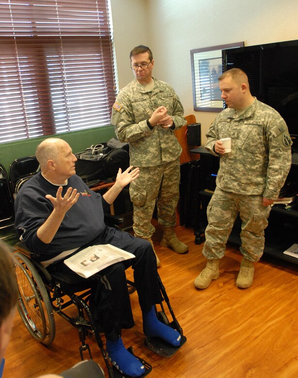 Staff Sgt. Scott Griffin, center, public affairs operations sergeant, and Sgt. Dennis DePrisco, broadcast journalist, both with the U.S. Army Reserve’s 207th Public Affairs Detachment, swaps stories with a veteran during a visit to the Colorado State Veterans Home at Fitzsimmons, Jan. 9. Soldiers of the 207th PAD ate lunch and visited with the veterans who reside in the Veterans Home.