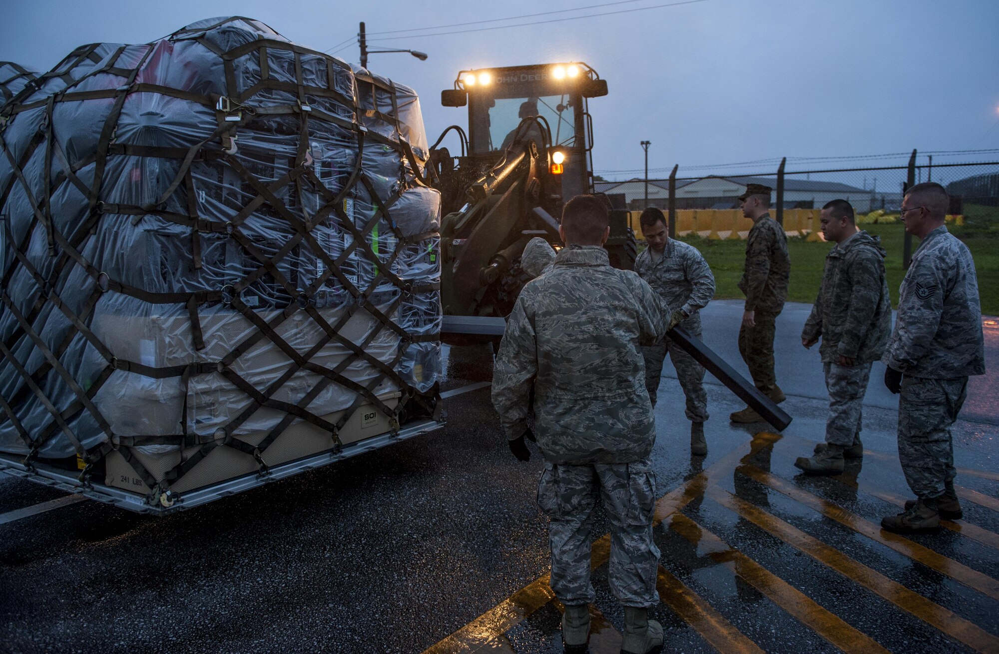 Members of the 353rd Special Operations Support Squadron unloads a pallet during a two week exercise Jan. 11, 2016, at Marine Corps Air Station Futenma, Japan. These exercises allow the 353rd SOSS to adapt and overcome potential issues they could encounter in a deployed environment while in a deployed enviroment. (U.S. Air Force photo by Airman 1st Class Nick Emerick)