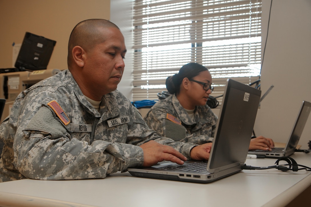 Sgt. Franklin Reyes (left) and Spc. Koniko Nakazato, Soldiers with the 302nd Quartermaster Company – Detachment 1, 9th Mission Support Command, U.S. Army Reserve, utilize recently installed laptops to check their military emails and conduct mandatory online training during their weekend battle assembly, here, at the U.S. Army Reserve Center, Saipan, Jan. 10. Prior to the installation of the Deployed Digital Training Campus (DDTC) and 20 laptops, Soldiers had limited access to computers during their weekend battle assembly trainings.