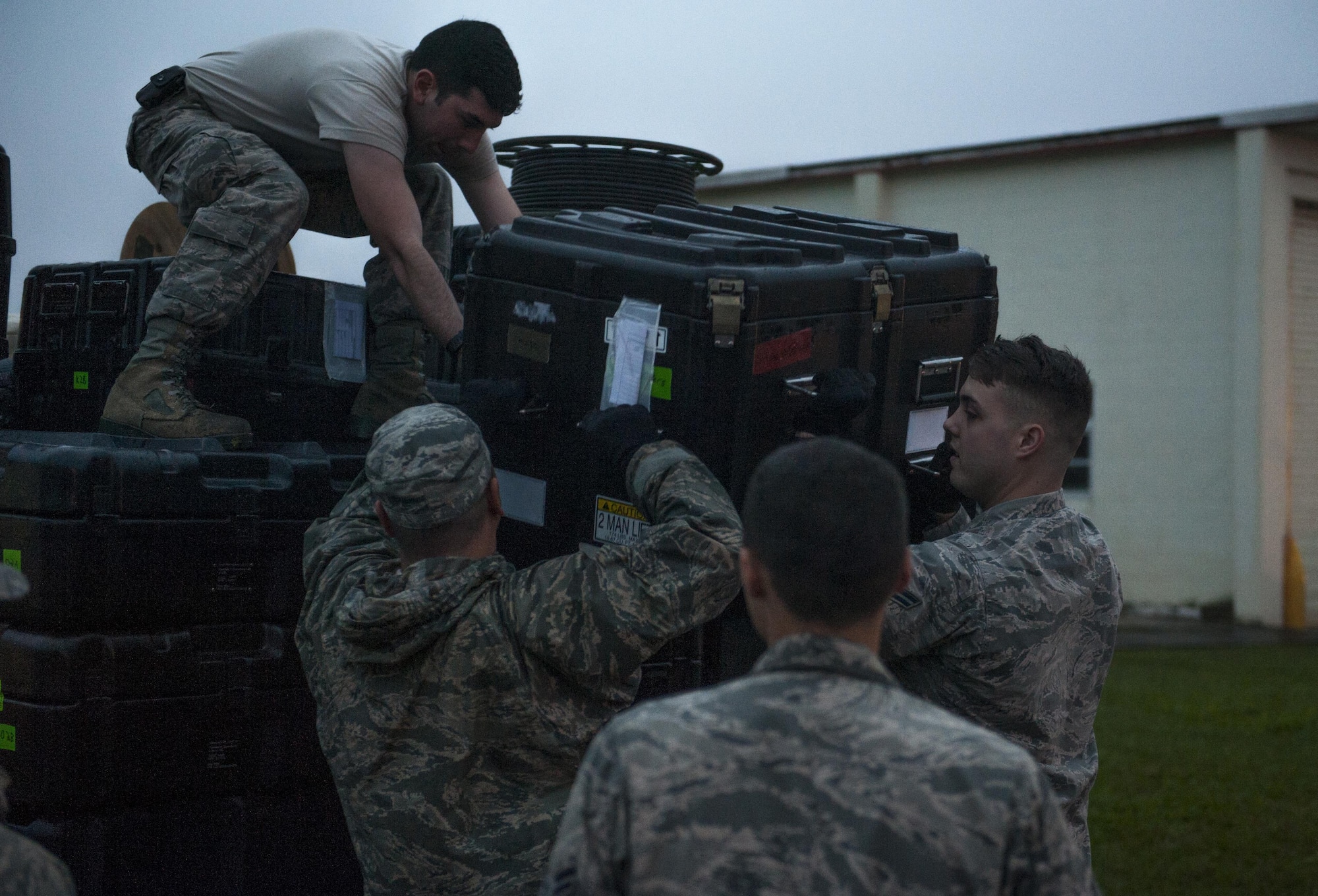 Members of the 353rd Special Operations Support Squadron unloads a pallet during a two week exercise Jan. 11, 2016, at Marine Corps Air Station Futenma, Japan. This two week exercise is being held in anticipation of upcoming deployments for the 353rd SOSS in the Indo-Pacific theater. (U.S. Air Force photo by Airman 1st Class Nick Emerick)