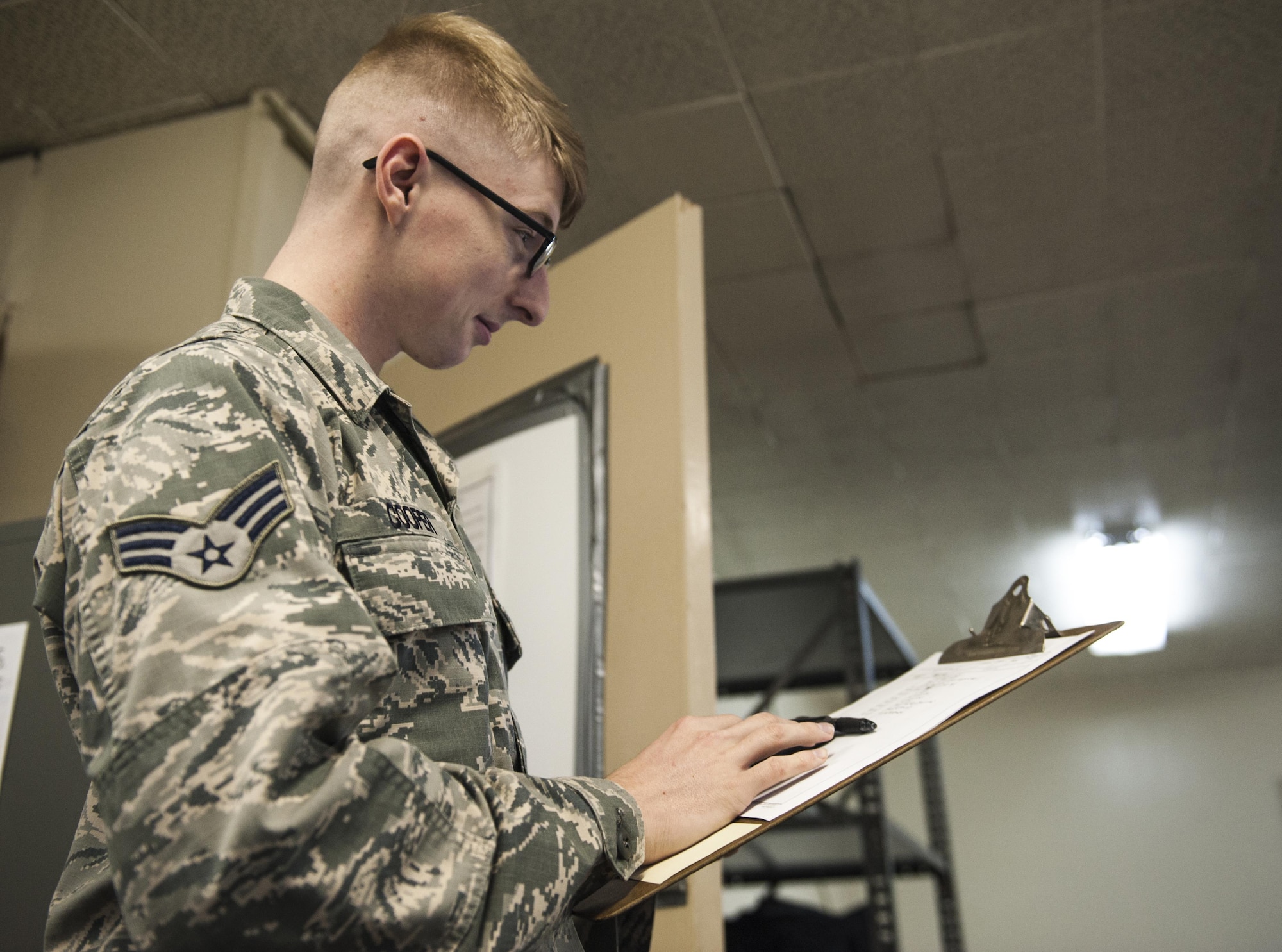 U.S. Air Force Senior Airman Corbin Cooper, 353rd Special Operations Support Squadron client systems support technician, reviews a checklist while setting up for the 353rd SOSS exercise on Jan. 11, 2016, at Marine Corps Air Station Futenma, Japan. Field exercises allow for preparation for rapid deployment, which is a necessity in the Indo-Asia-Pacific area of resposibility. (U.S. Air Force photo by Airman 1st Class Nick Emerick)