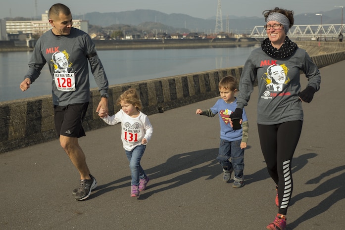 Station residents run toward the finish line during the 8th Annual Martin Luther King Jr. 2.5k run or walk at Marine Corps Air Station Iwakuni, Japan, Jan. 16, 2016. The Youth and Teen Center started this event in remembrance of Dr. Martin Luther King Jr. and to provide residents another opportunity to be active within the community. The YTC provides station residents with various opportunities to participate and volunteer for events.