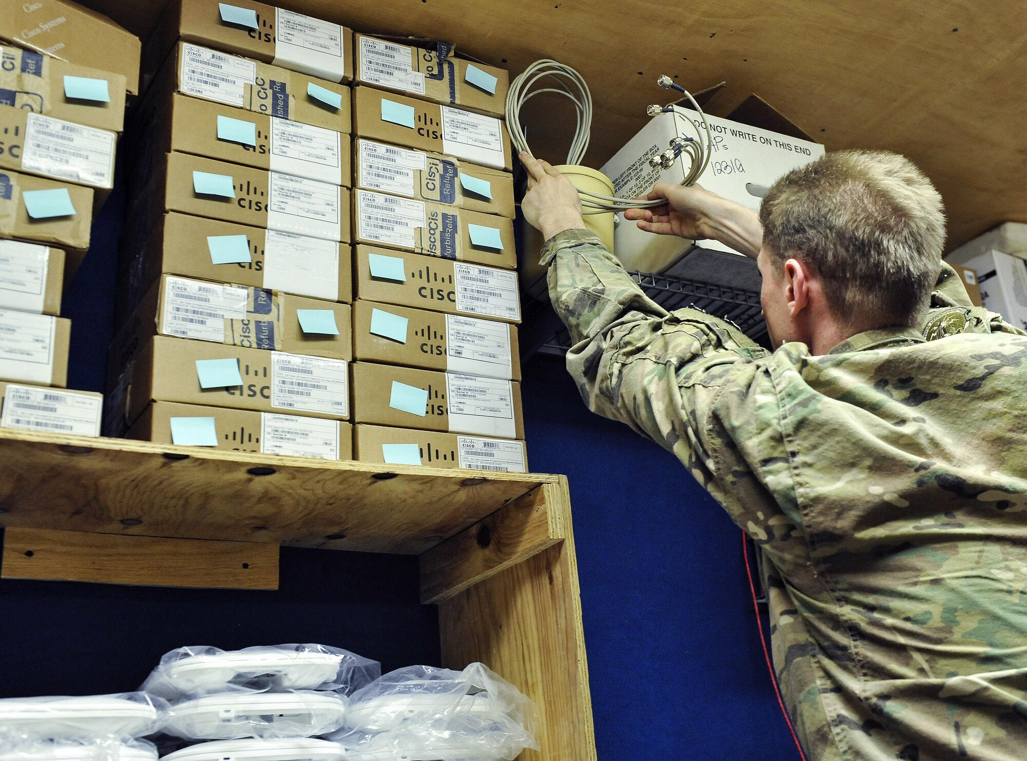 Senior Airman David Baer, 455th Expeditionary Communications Squadron cyber transport technician, puts a wireless router into inventory at Bagram Airfield, Afghanistan, Jan .13, 2016. The Network Management section is tasked with installing and maintaining the physical assets inside the building. (U.S. Air Force photo by Tech. Sgt. Nicholas Rau)