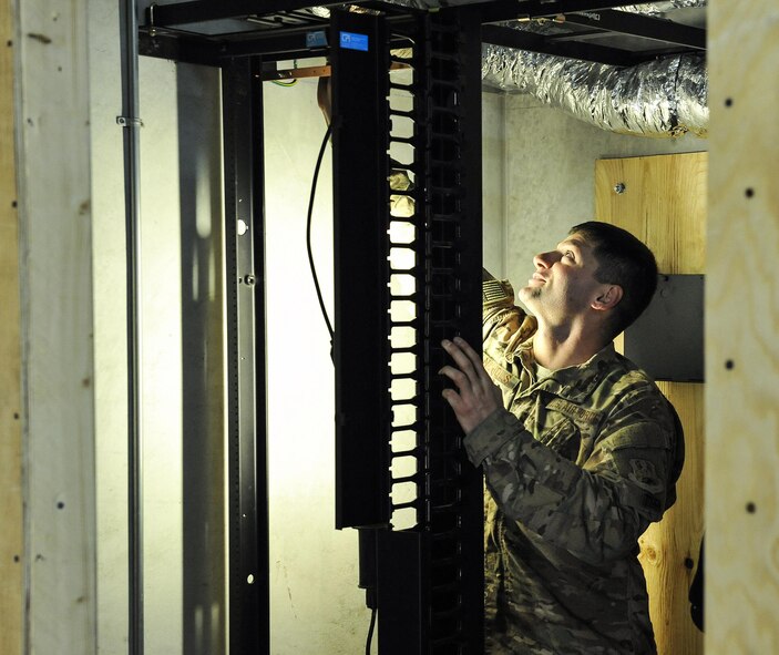 Staff Sgt. Adam Nichols, 455th Expeditionary Communications Squadron Cable technician, builds a communications closet for the future location of the Communications Focal Point at Bagram Airfield, Afghanistan, Jan .13, 2016. The Cable section is responsible for the infrastructure from outside the building up to the inside wall. (U.S. Air Force photo by Tech. Sgt. Nicholas Rau)