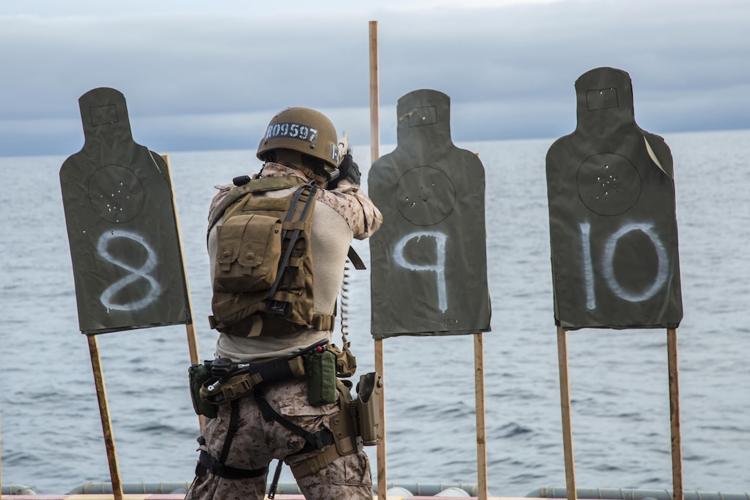 A U.S. Marine fires his weapon on deck during an exercise aboard the USS Boxer at sea, Jan. 18, 2016. U.S. Marine Corps photo by Sgt. Hector de Jesus