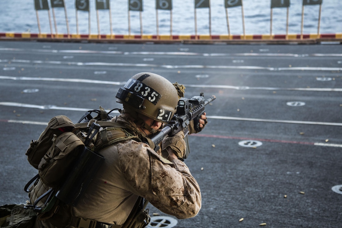 A U.S. Marine fires his weapon on deck during an exercise aboard the USS Boxer at sea, Jan. 18, 2016. U.S. Marine Corps photo by Sgt. Hector de Jesus