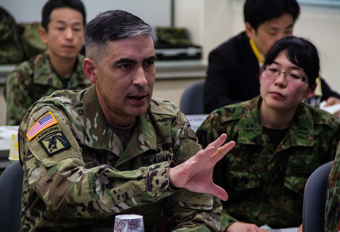 U.S. Army Col. Luis Pomales (left), a San Juan, Puerto Rico, native serving as the director of the Army Reserve Engagement Team-Japan (ARET-J), explains the U.S. Army Reserve's structure, missions and capabilities to Japan Ground Self-Defense Force (JGSDF) Reserve Component service members during a command briefing conducted at JGSDF Western Army’s headquarters in Camp Kenjun, Japan, Jan. 15, 2016. The briefing was one of several cultural, social and military training engagements designed to enhance the bilateral partnership between ARET-J and the JGSDF Western Army's Reserve Component. (U.S. Army photo by Sgt. John L. Carkeet IV, U.S. Army Japan)